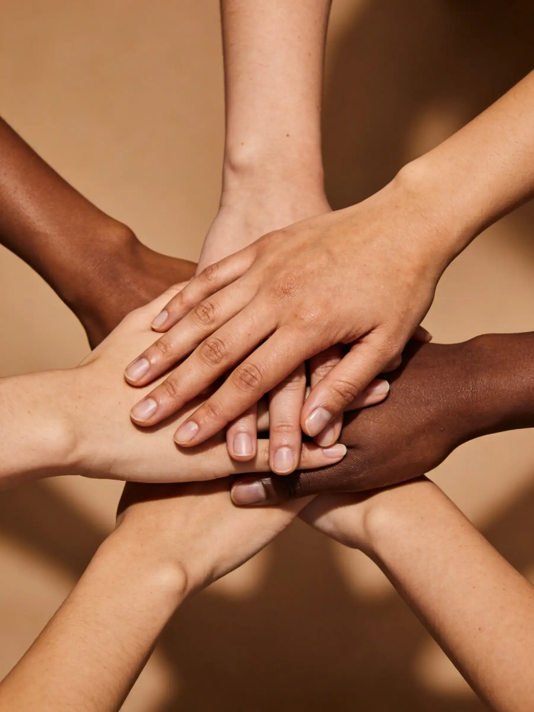 Close-up of two hands gently touching in a supportive gesture