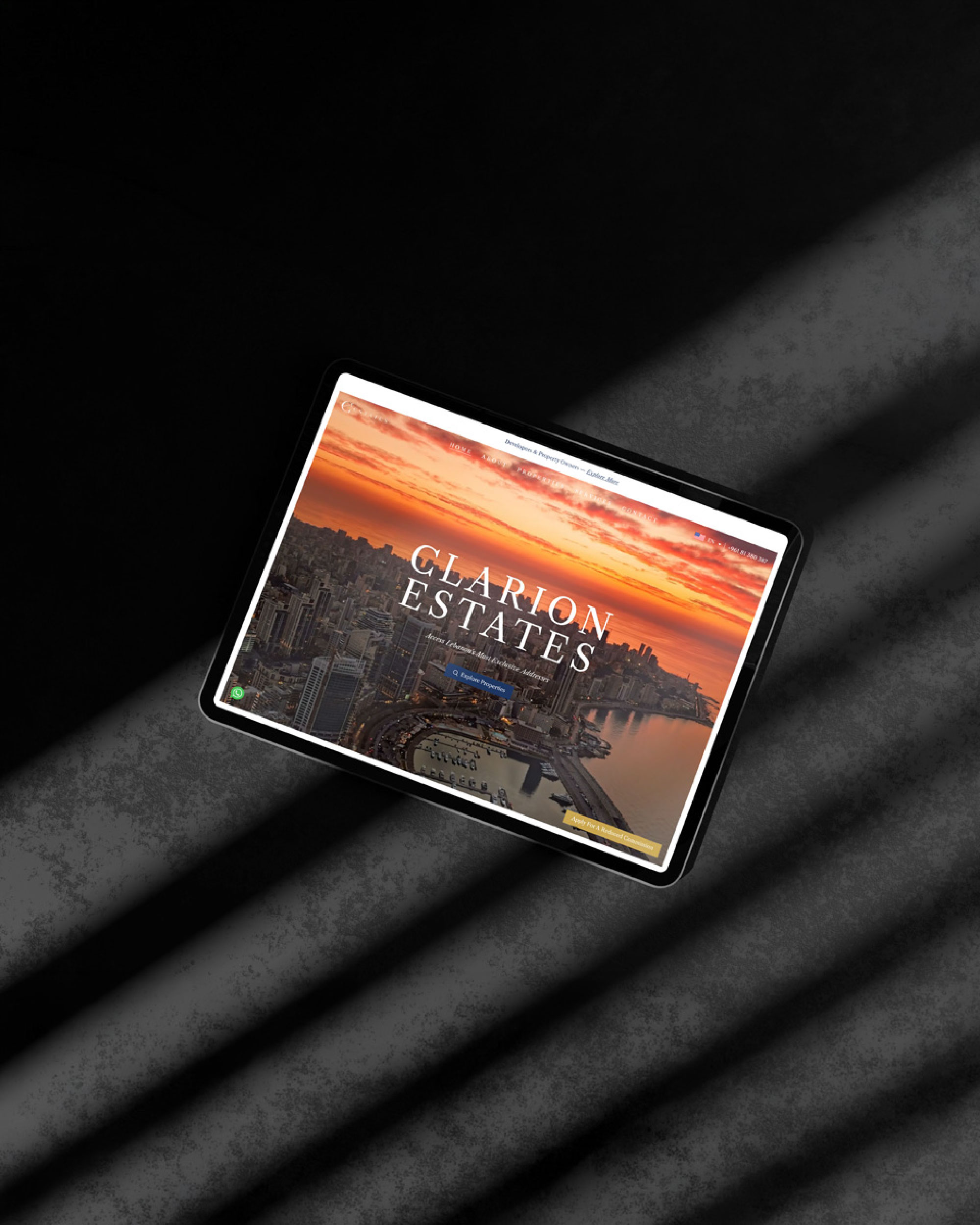 Clarion Estates homepage displayed on a tablet over a sunset city photograph.