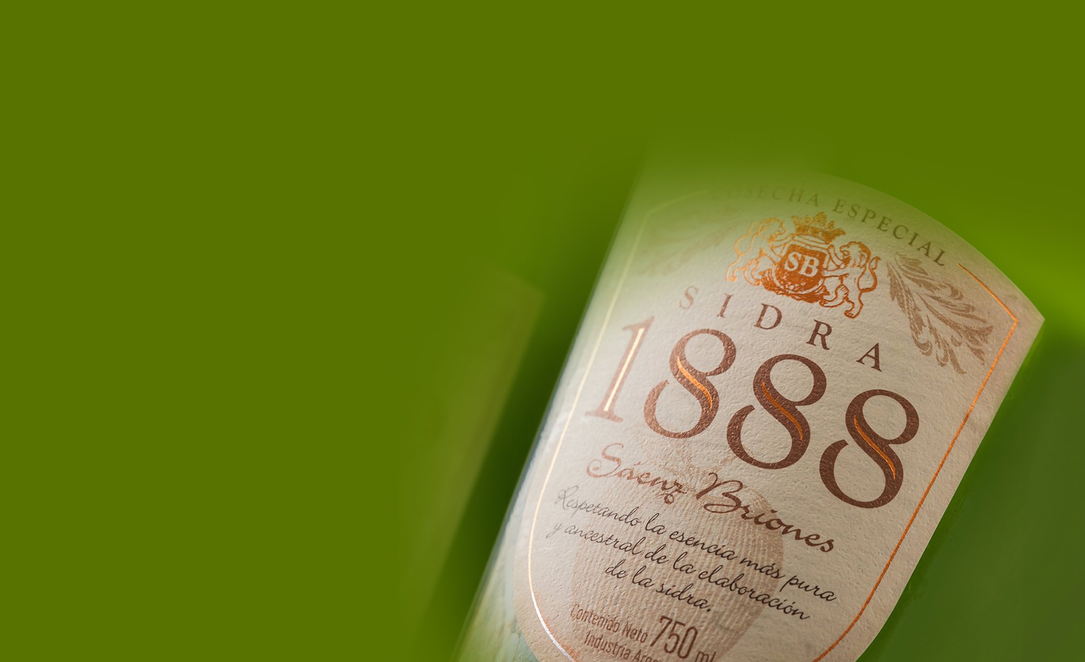 A tilted cider bottle labeled "Sidra 1888" against a vibrant green background, conveying a sense of tradition and elegance.