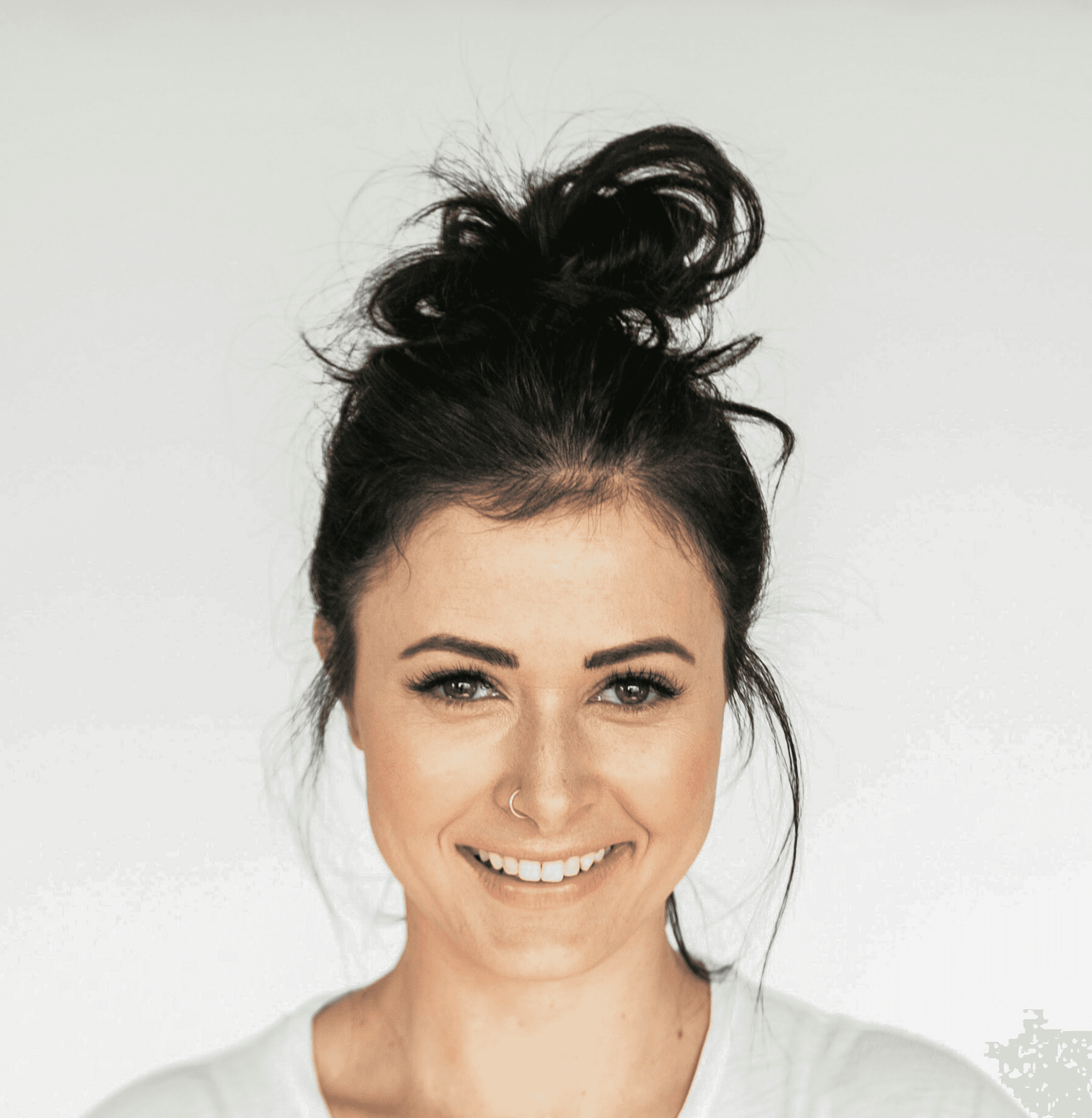 woman in white crew neck shirt smiling