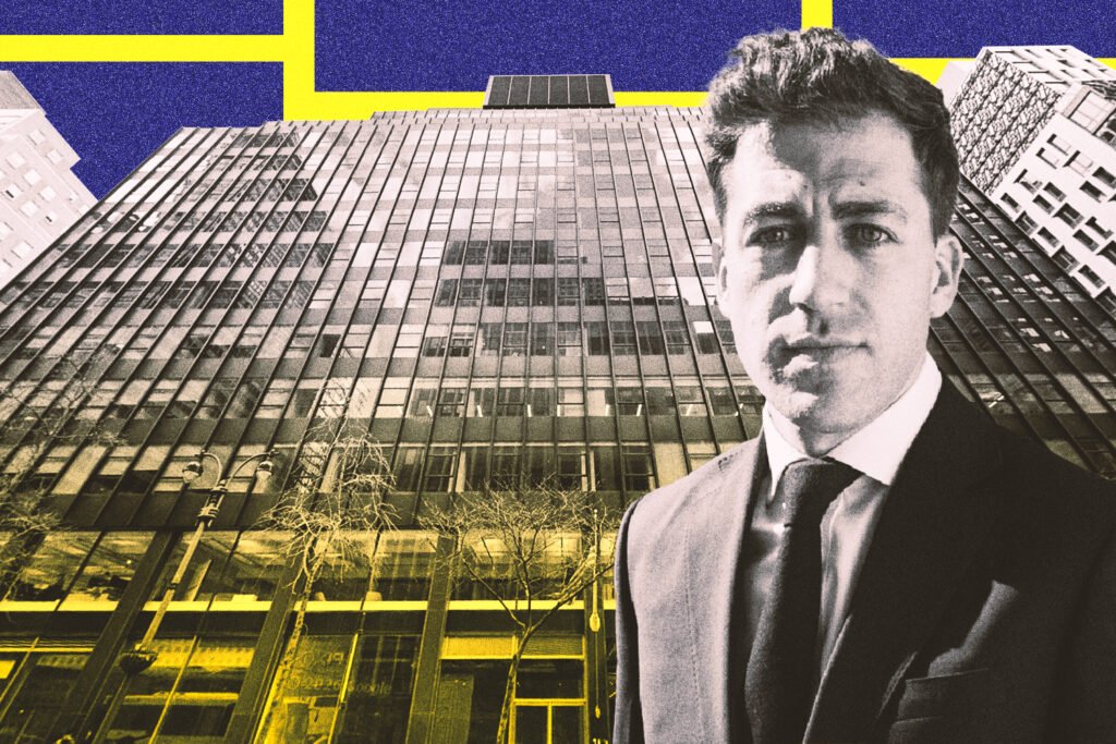 Tall modern skyscraper with vertical lines, viewed against a clear blue sky.