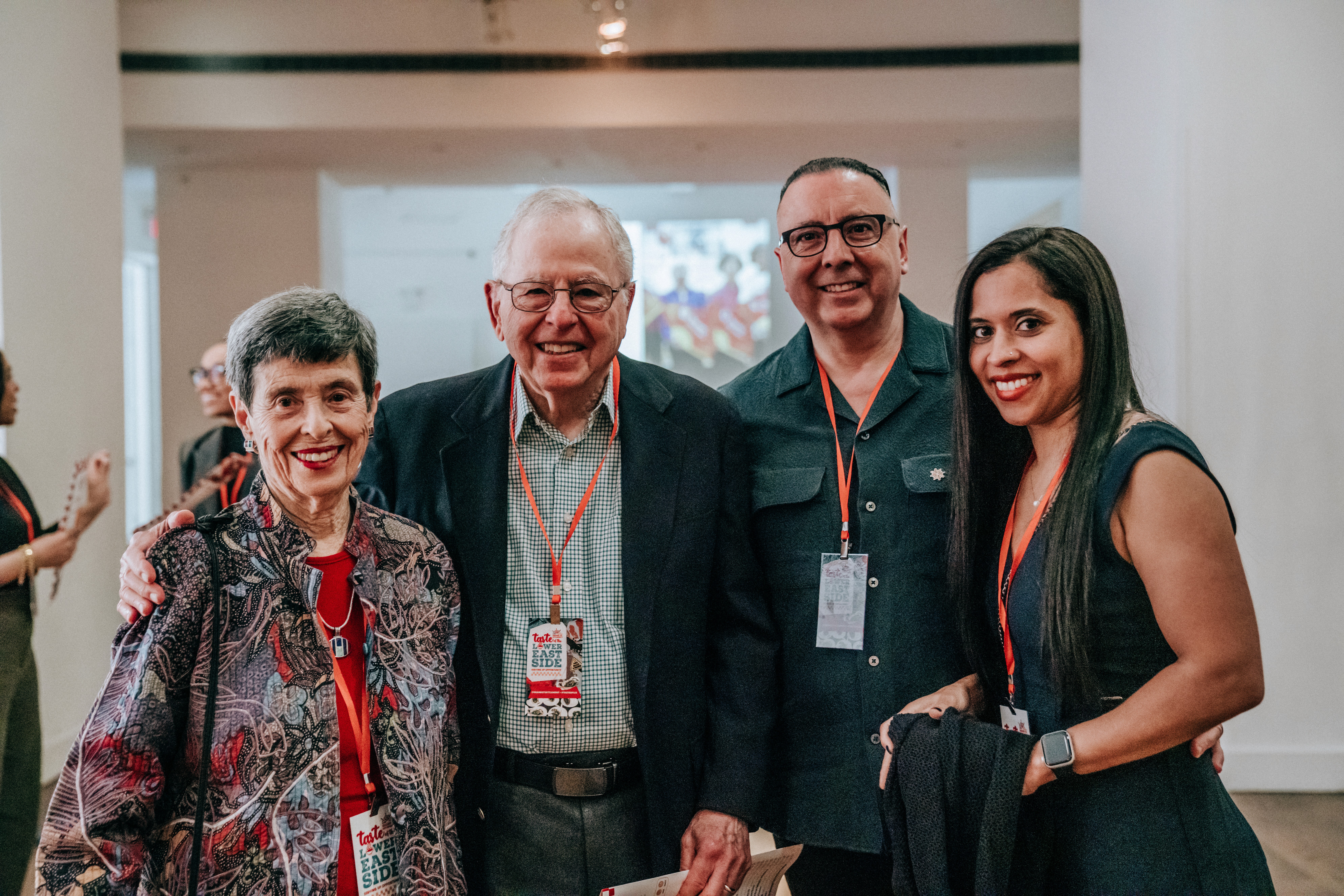 Four people pose for a photo in an event space