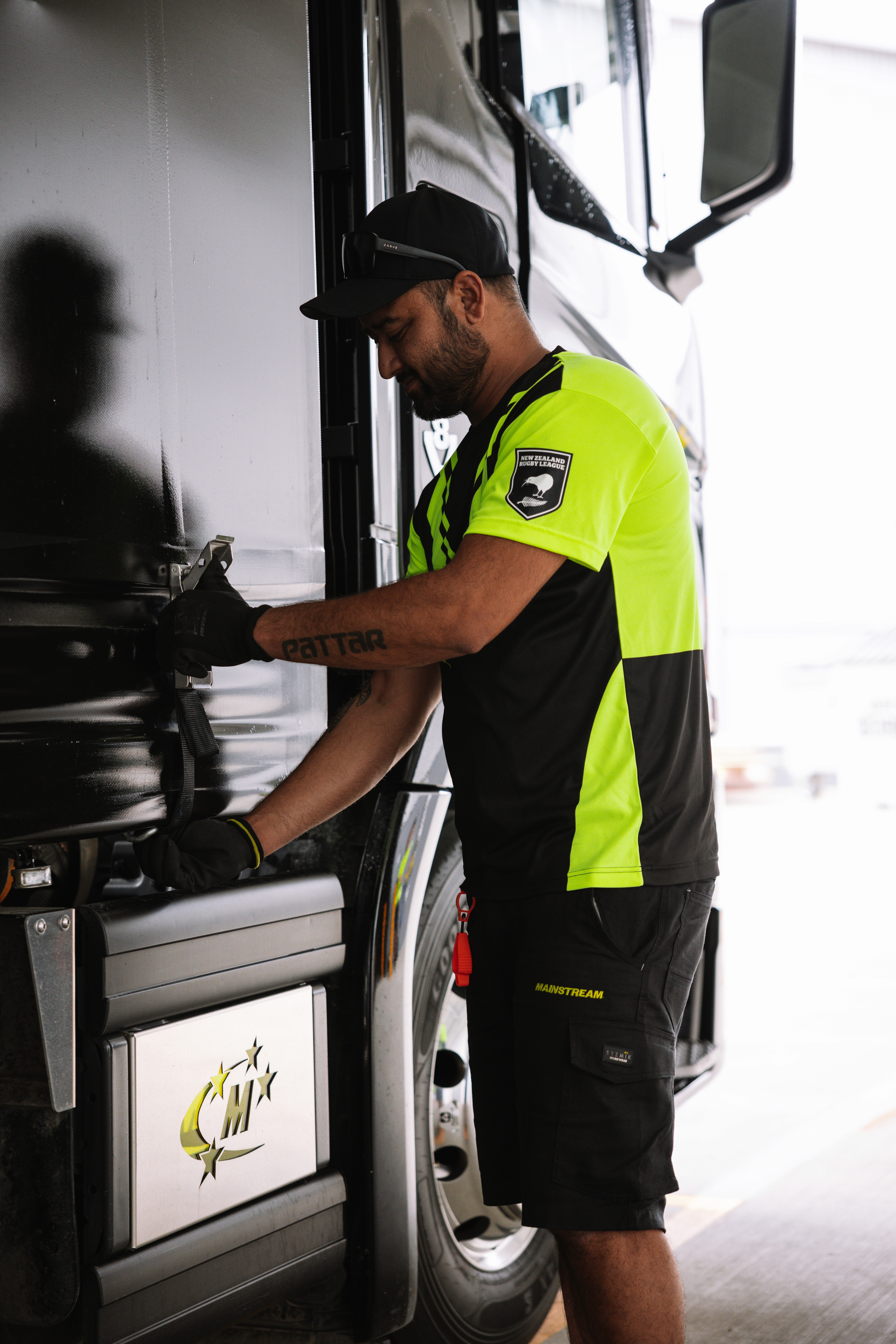 Top-down view of wind turbine over dry terrain with adjacent building