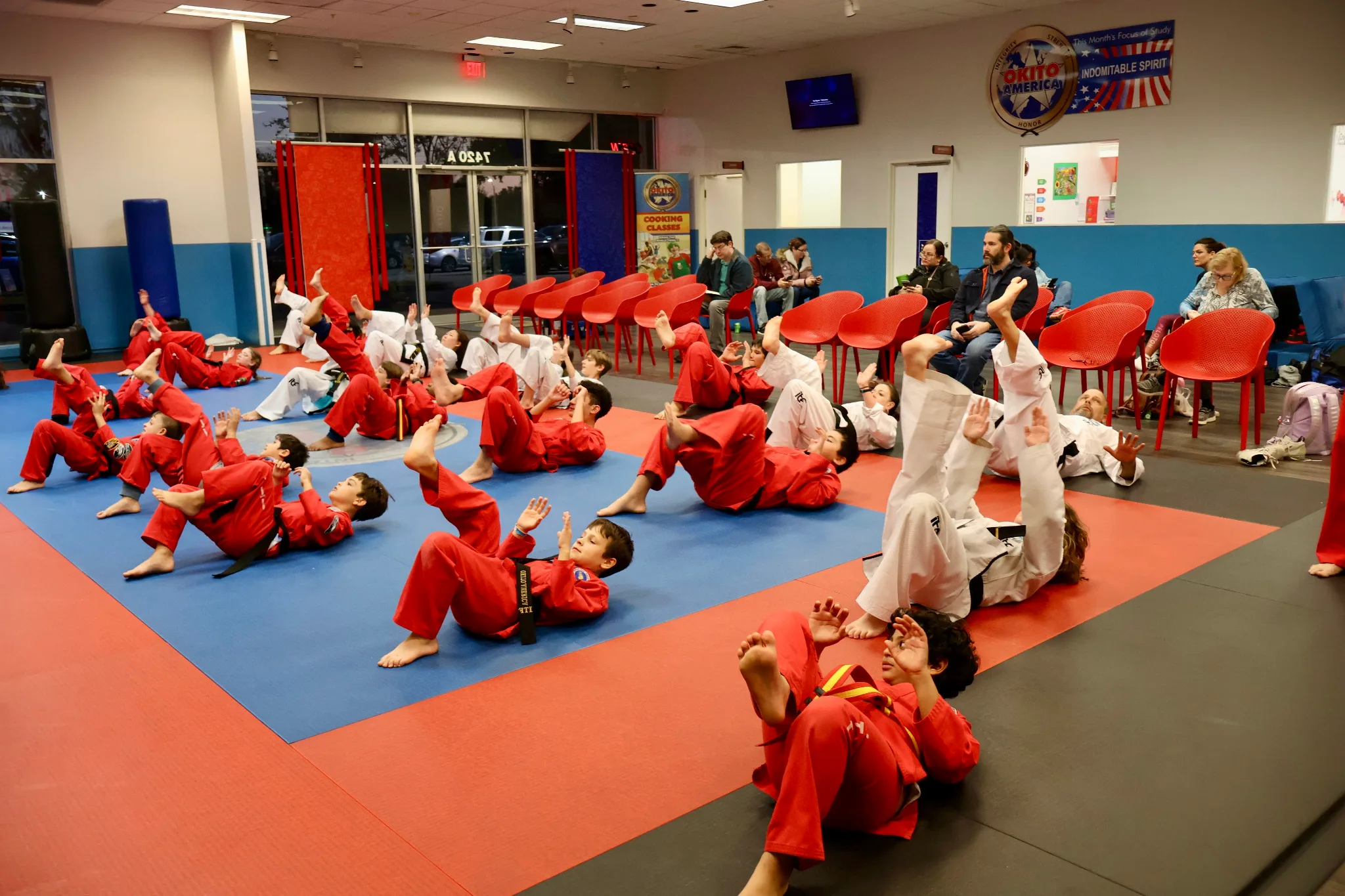 Students in class practicing an on the ground kick