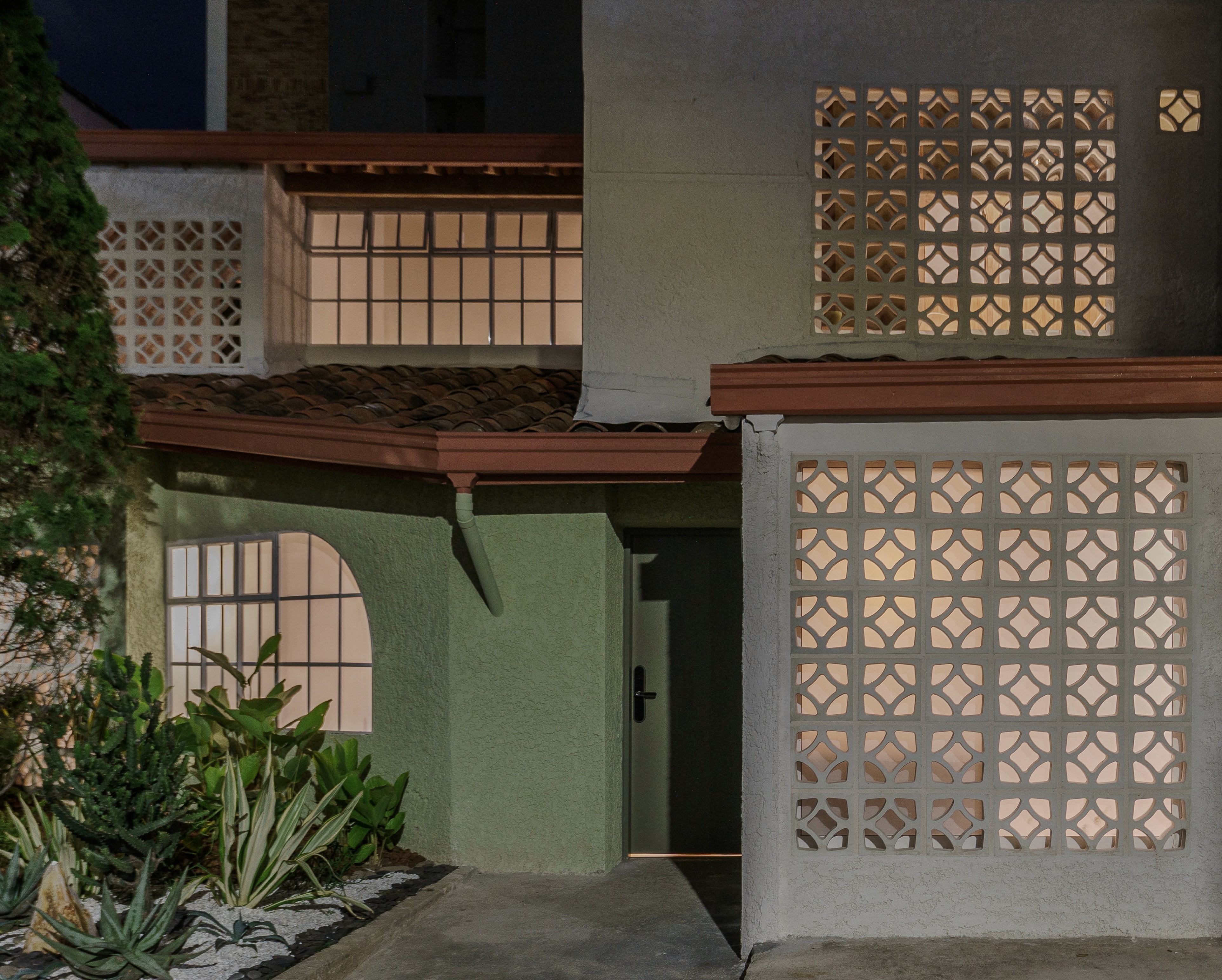 Double-height interior with flowing sculptural forms and warm raking light