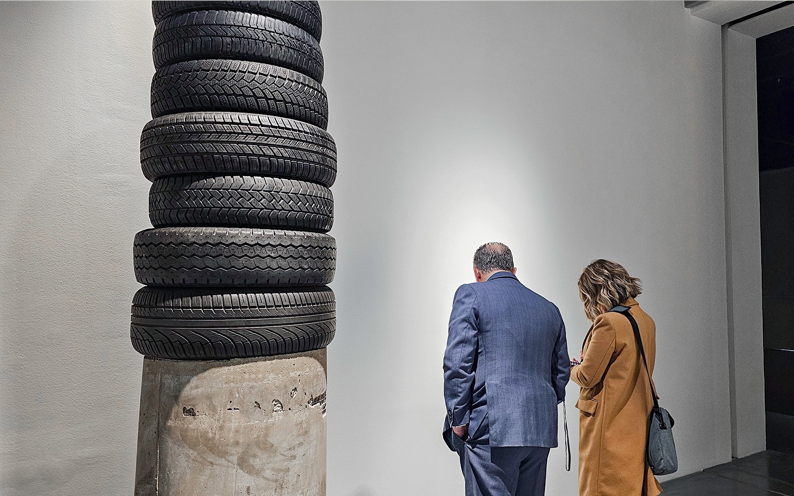 Visitors observing tire sculpture at Picasso's Birthplace Museum.