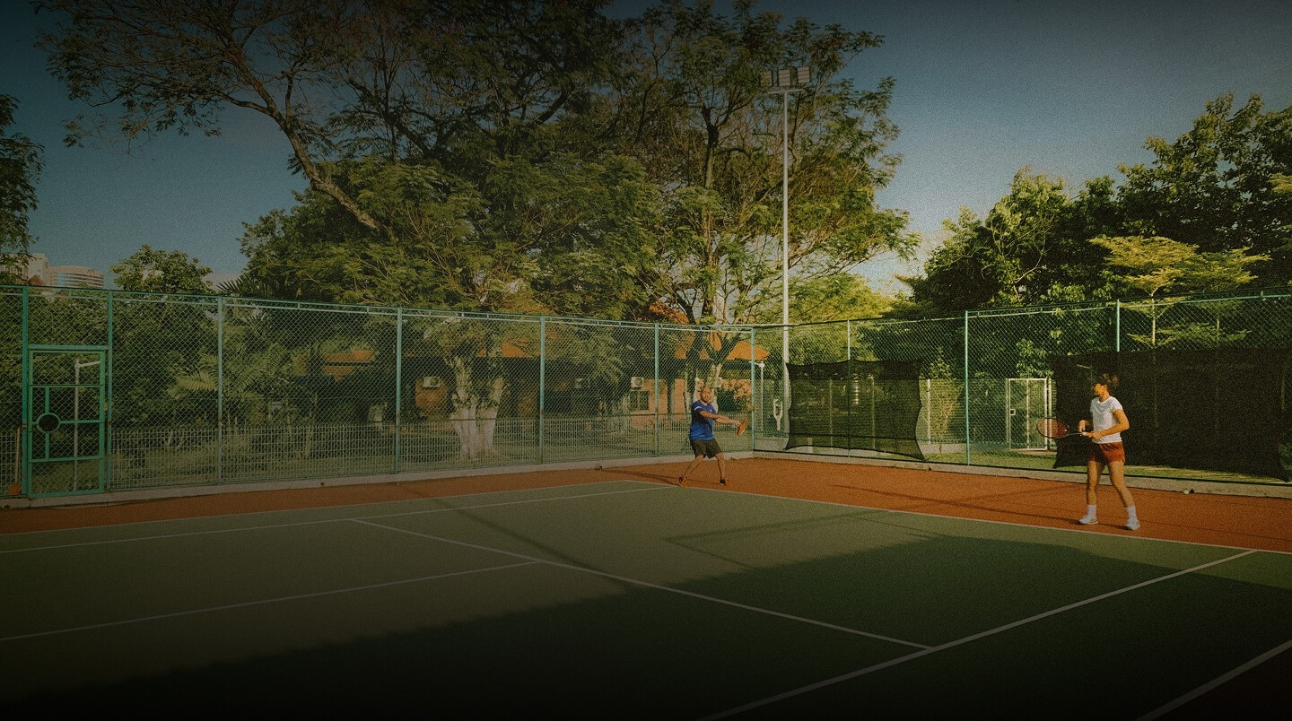 Professional tennis coach Stefan Stankovic teaching a students on a court in Falls Church, Virginia