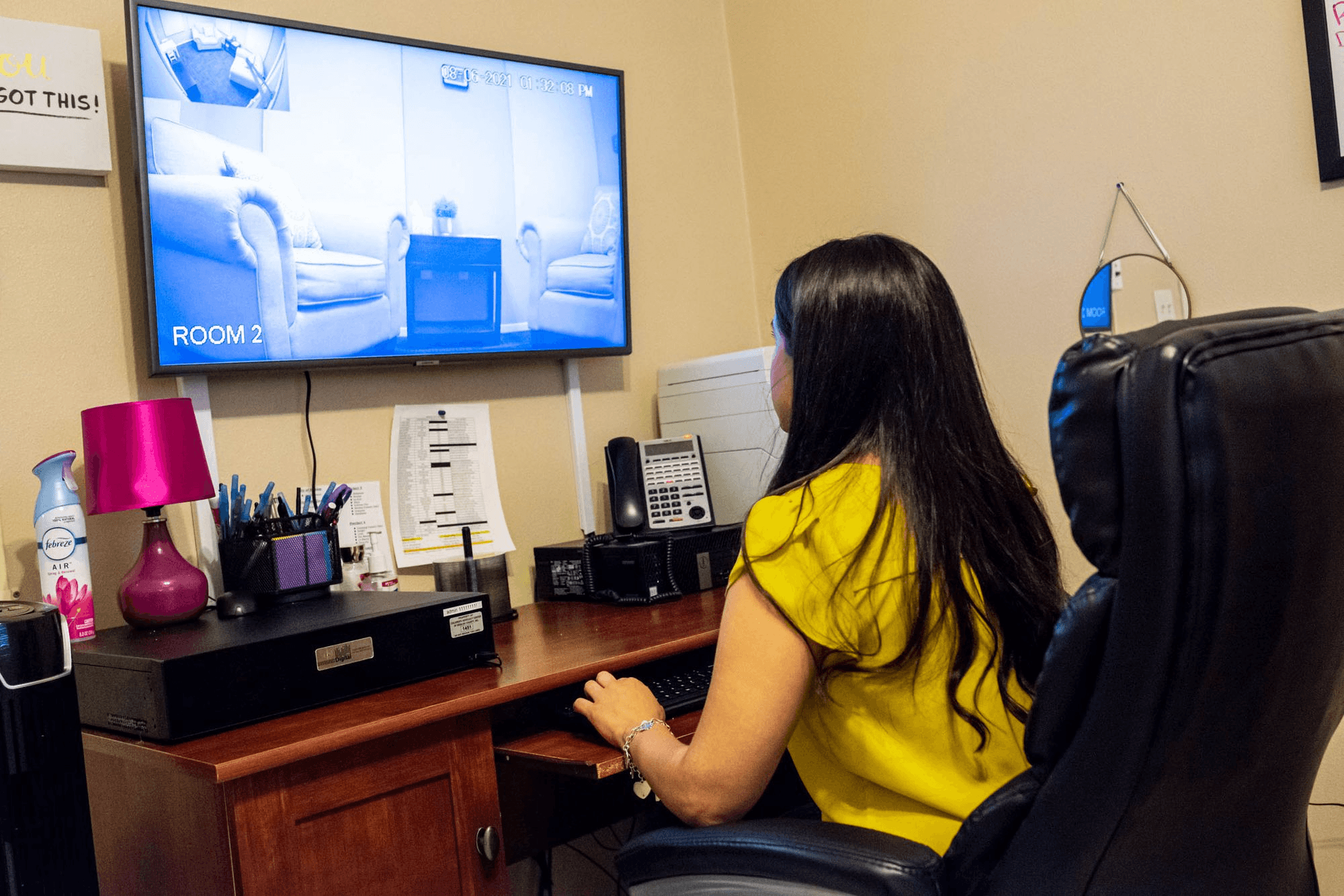 Forensic Interviewer Cassie Cruz checks the CACHSC's forensic interview audio and visual recording equipment. In a space adjacent to the interviewing room, CACHSC staff and representatives from law enforcement CPS and the DA monitor and collaborate to determine the appropriate actions for the case and for the child's healing.