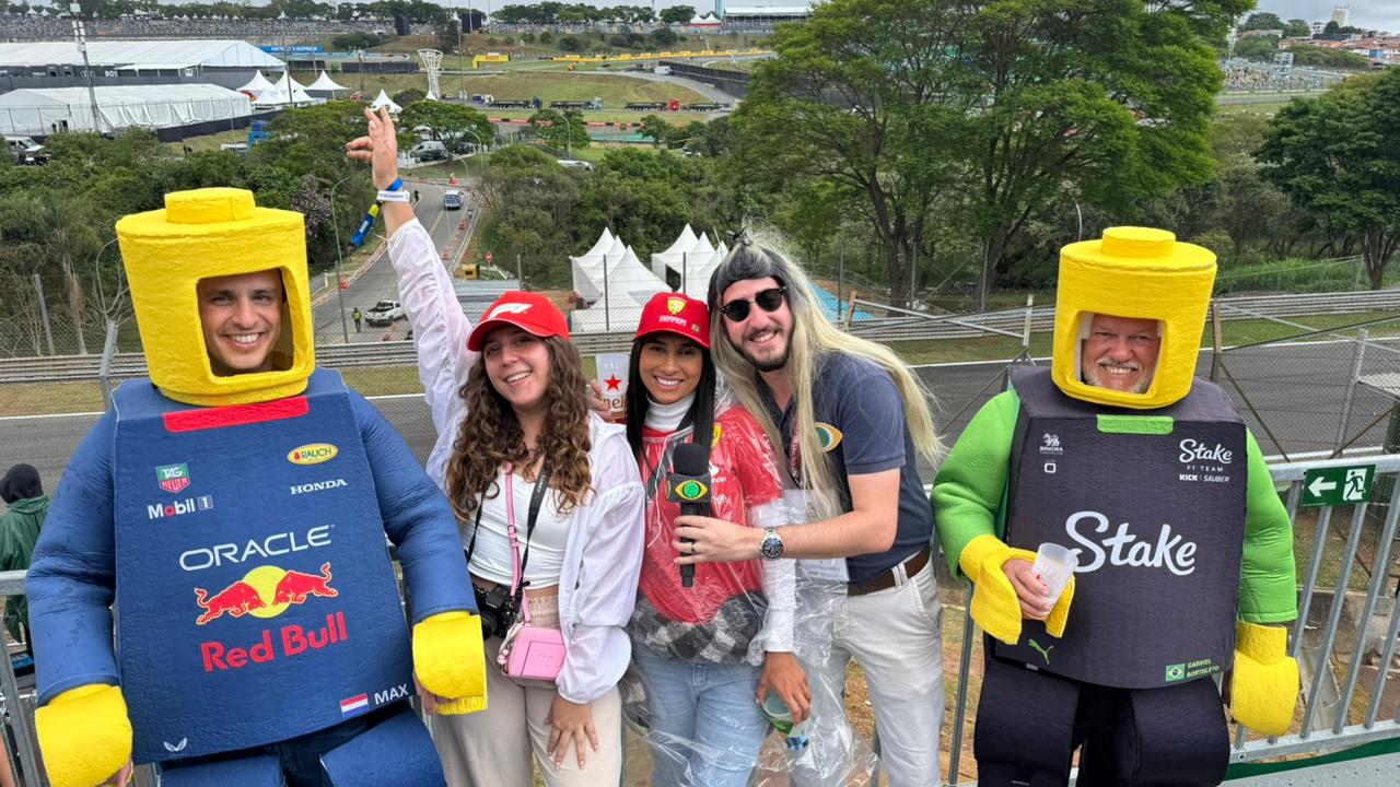 A cell phone sitting on top of a wooden table next to a keyboard