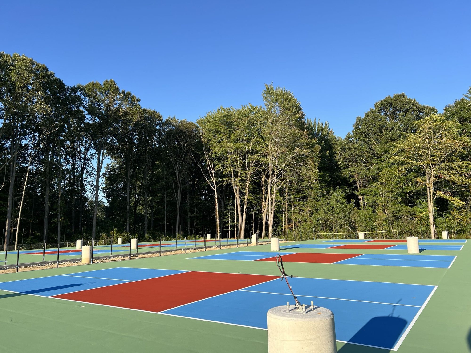 New pickleball courts lined up along the tree line at Solon Community Park in Solon, OH
