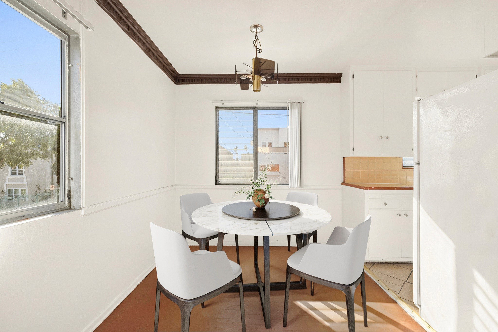 Dining area with modern table seating and window light inside unit at 436 Normandie Pl.