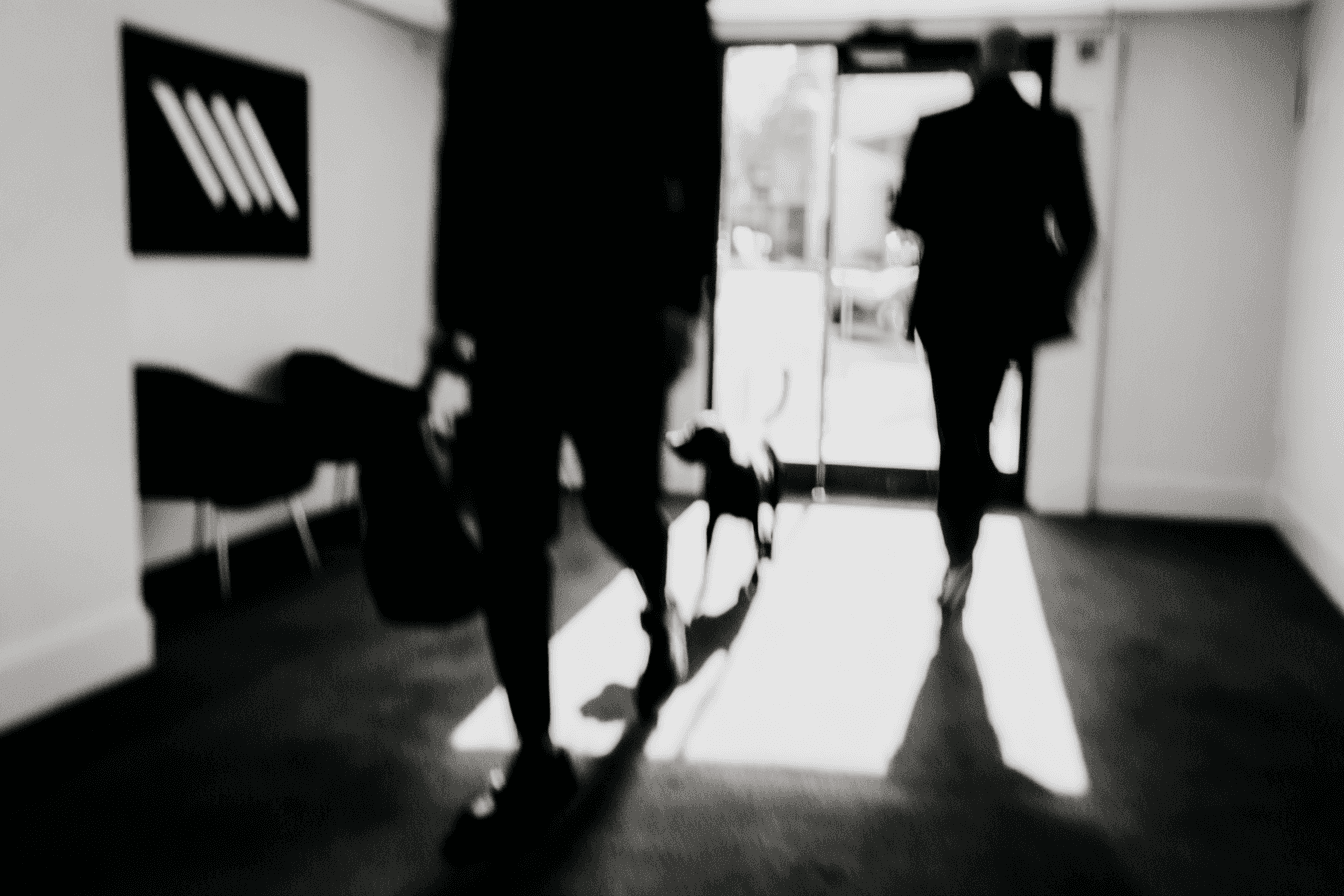 The image captures a moment of dynamic motion, depicting a male basketball player in mid-air as he reaches to shoot or pass the basketball.