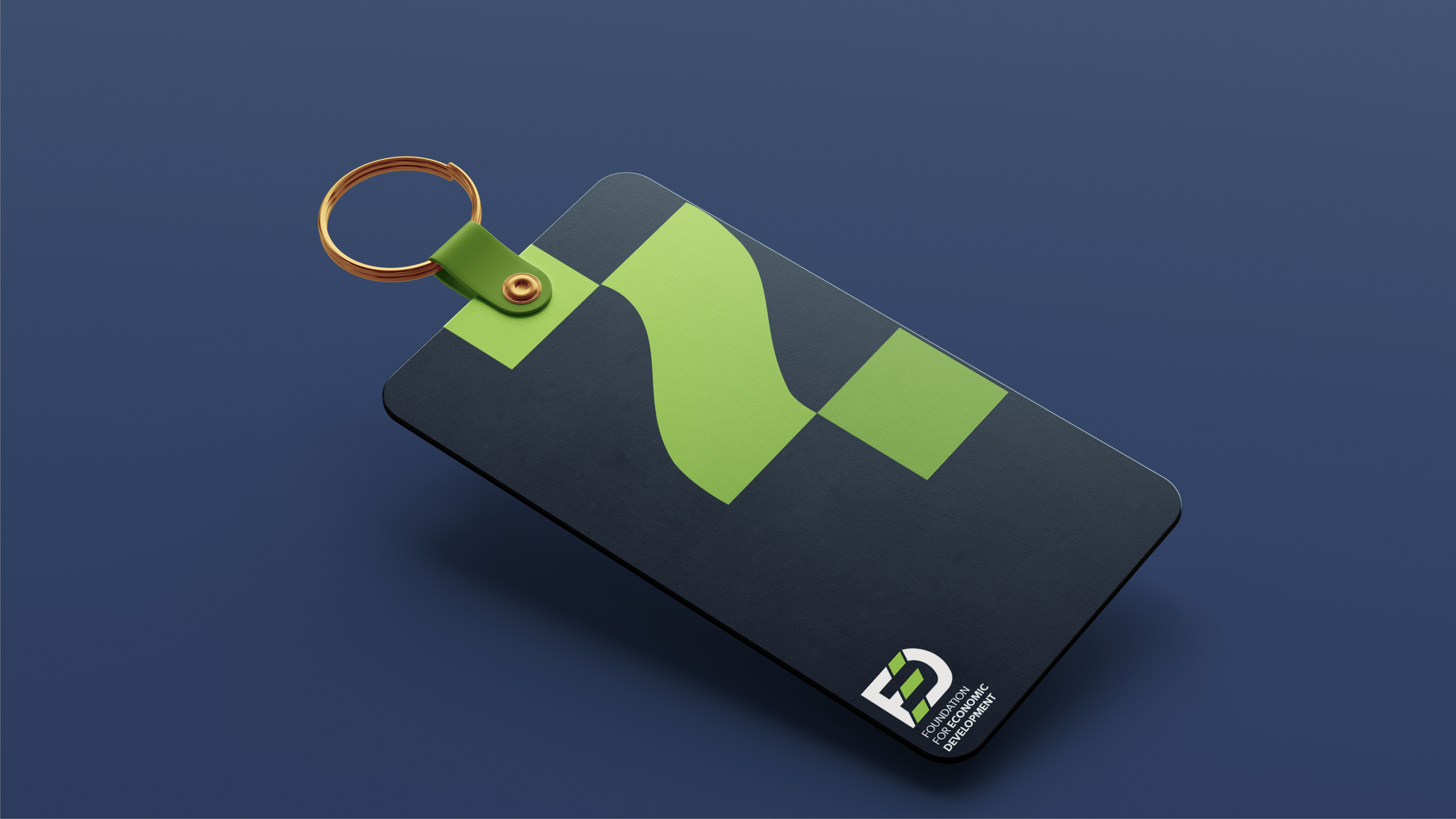 Keychain for foundation for economic development in blue with green abstract design.