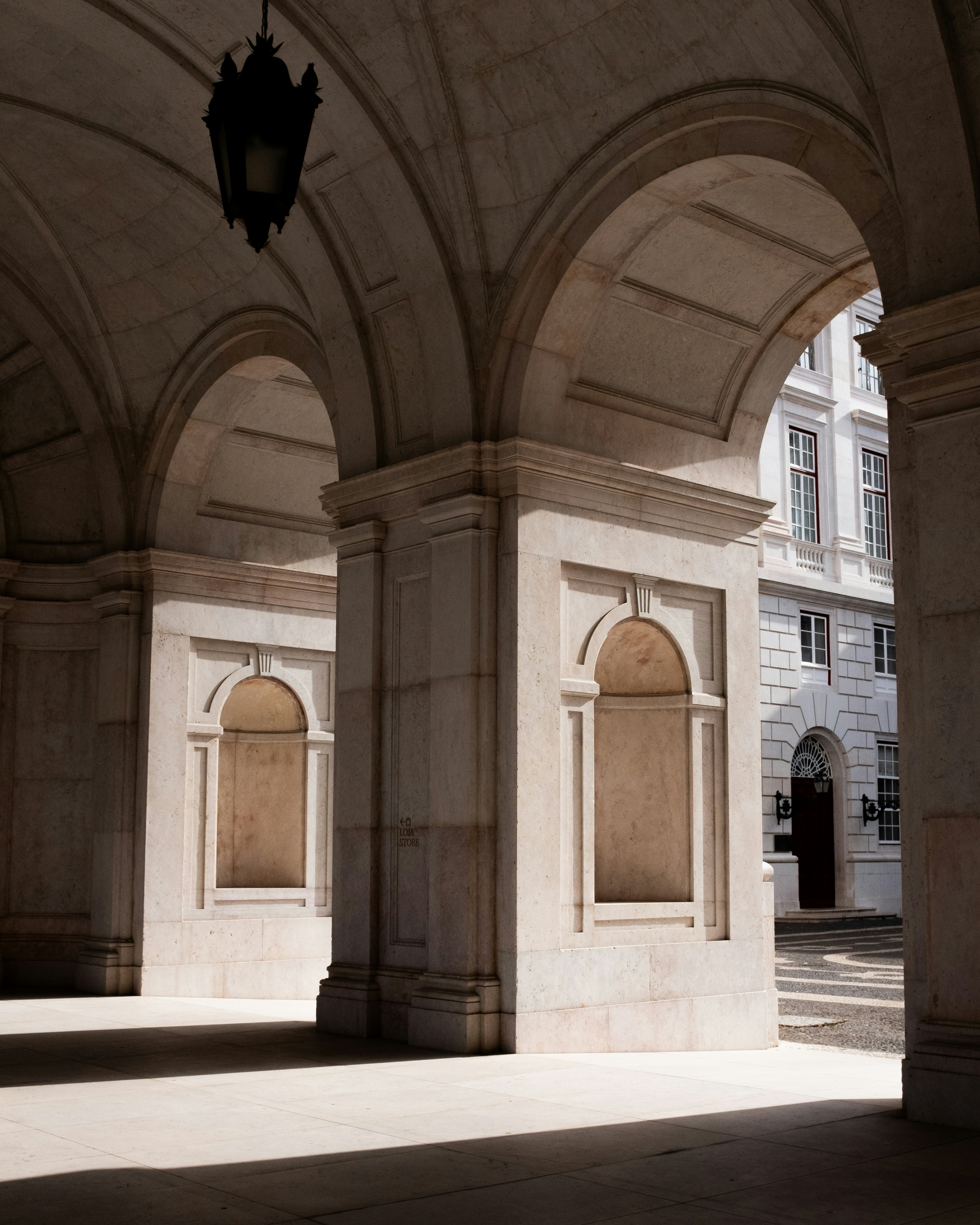 Arches and columns in a sunlit building interior