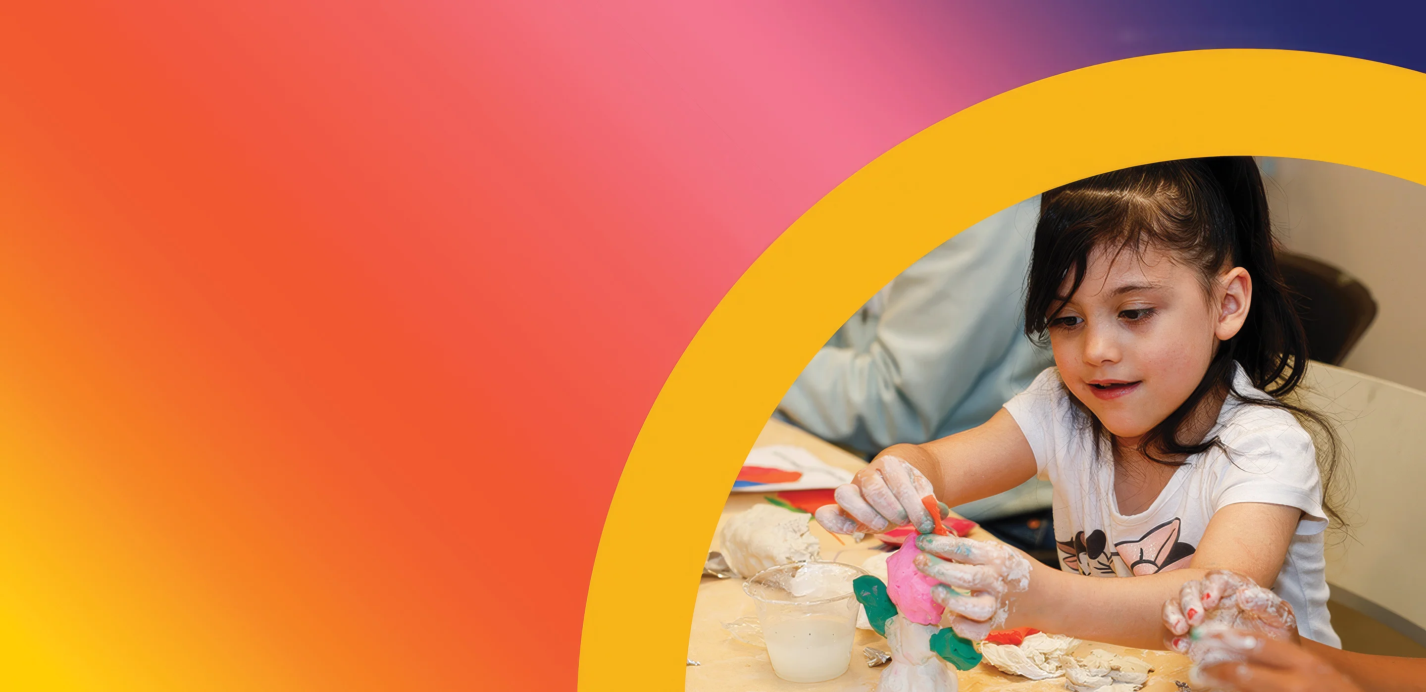 Child molding clay with messy hands