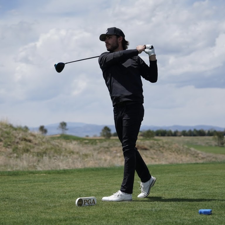 Jax finishing a swing with a driver.