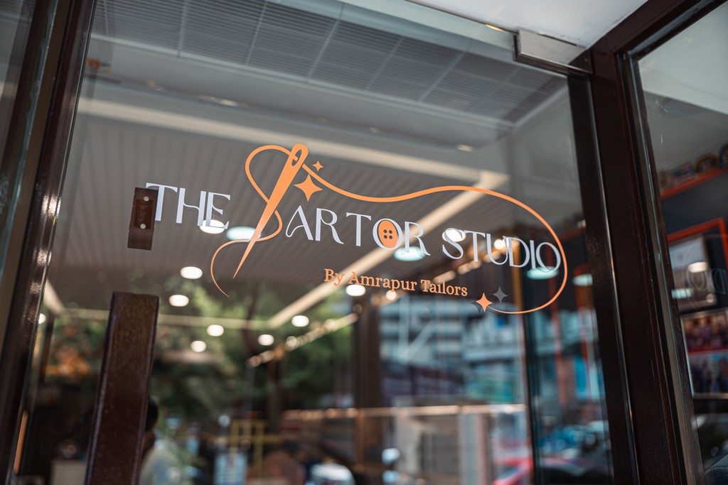 person leaning on wall while holding gray hat