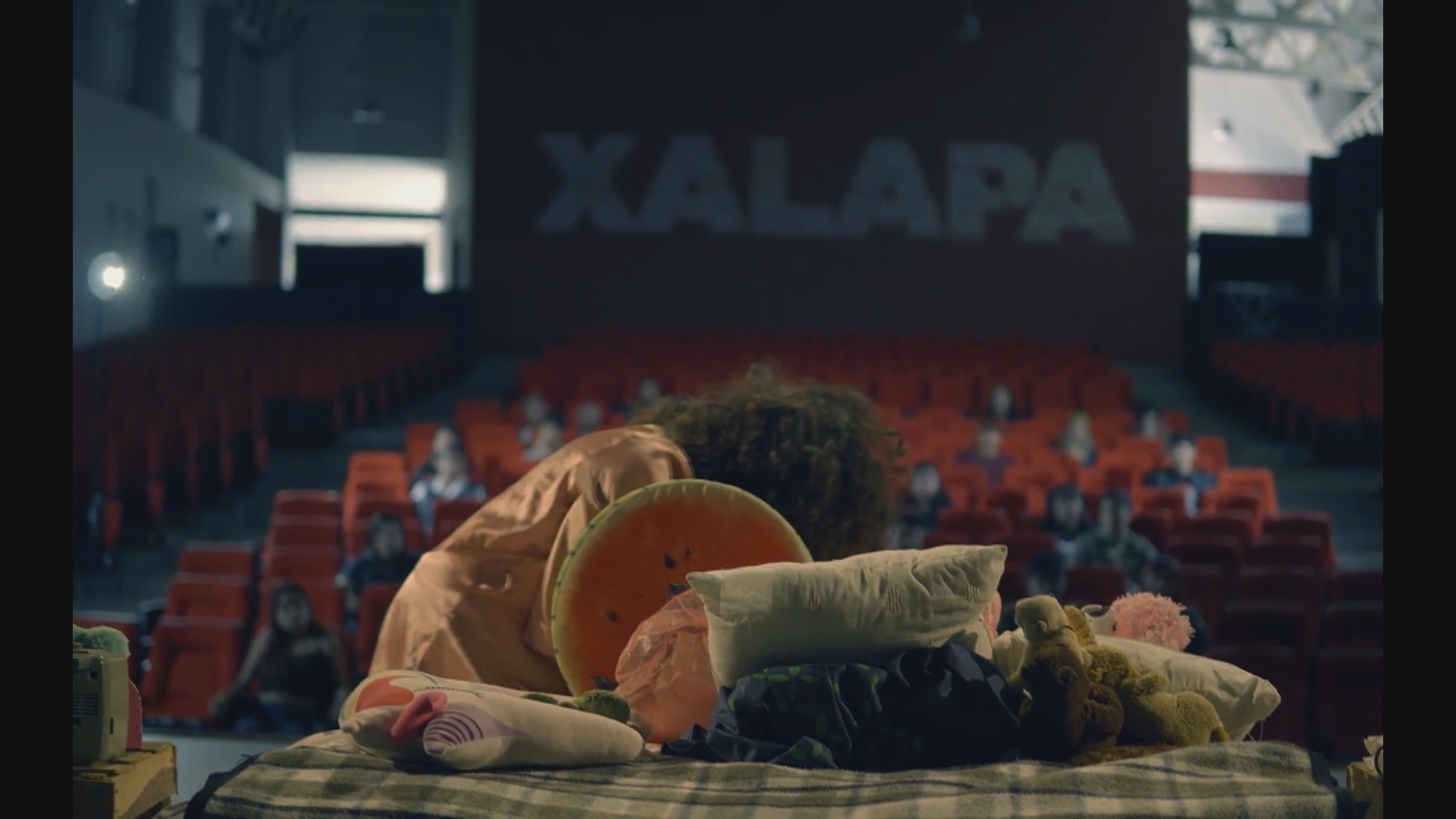 View of the French countryside through a stone villa’s open living room, with sofas and trees framing the scene