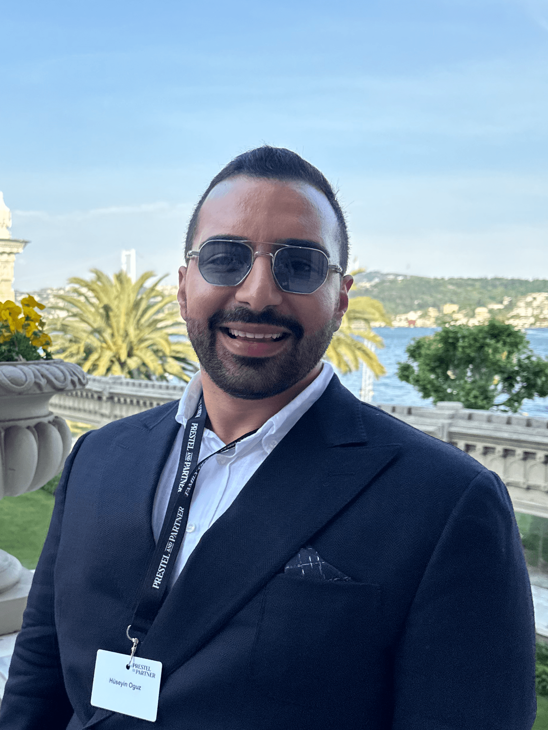 A young person with long, wavy hair sits in front of a plain background, looking directly at the camera.