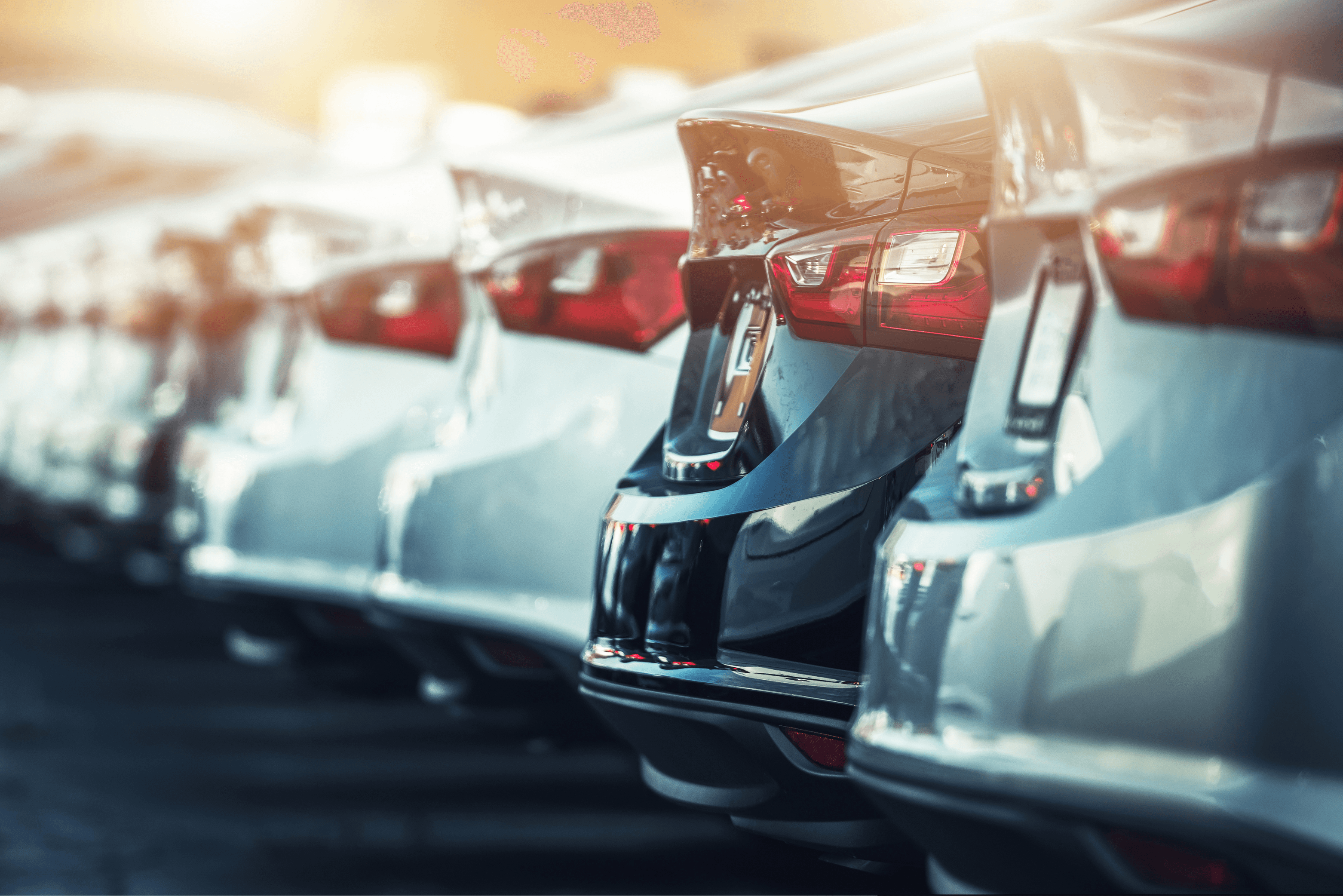  Front view of a powerful, aggressive-looking black sports car with red accents, partially shrouded in dramatic red and white smoke/mist against a red background.