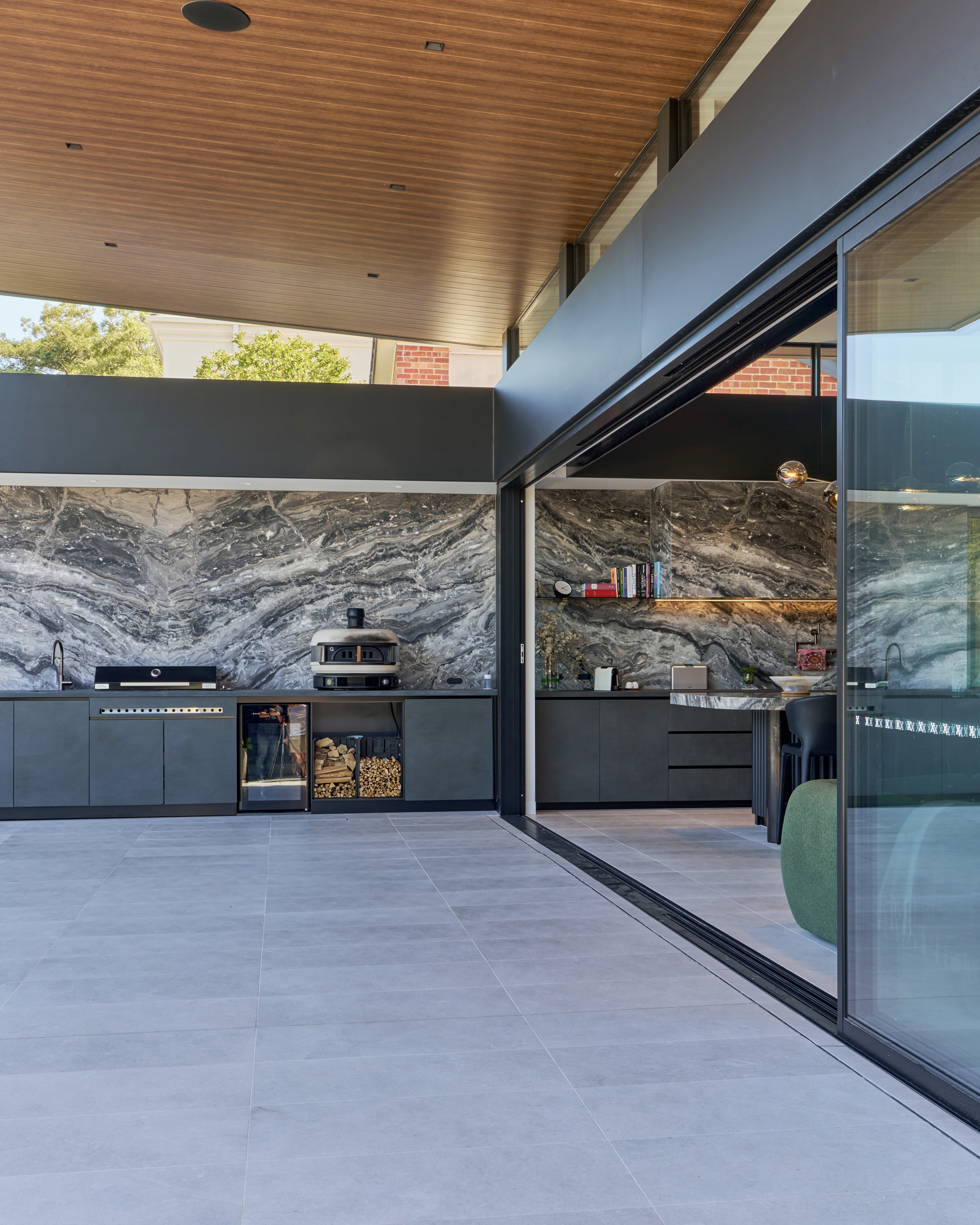 Alpine house nestled in a valley beneath a towering mountain.