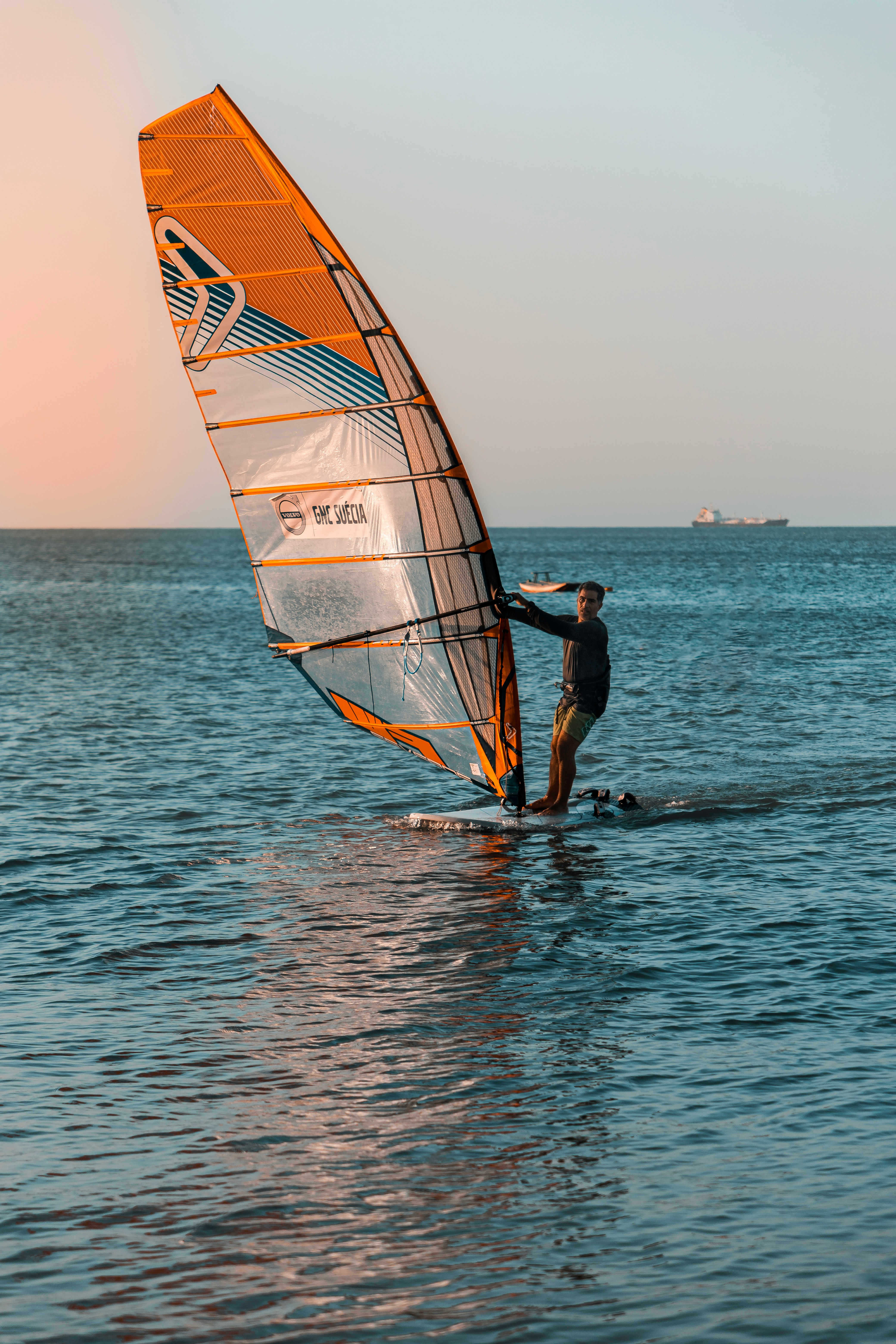 man in black shorts surfing on sea during daytime