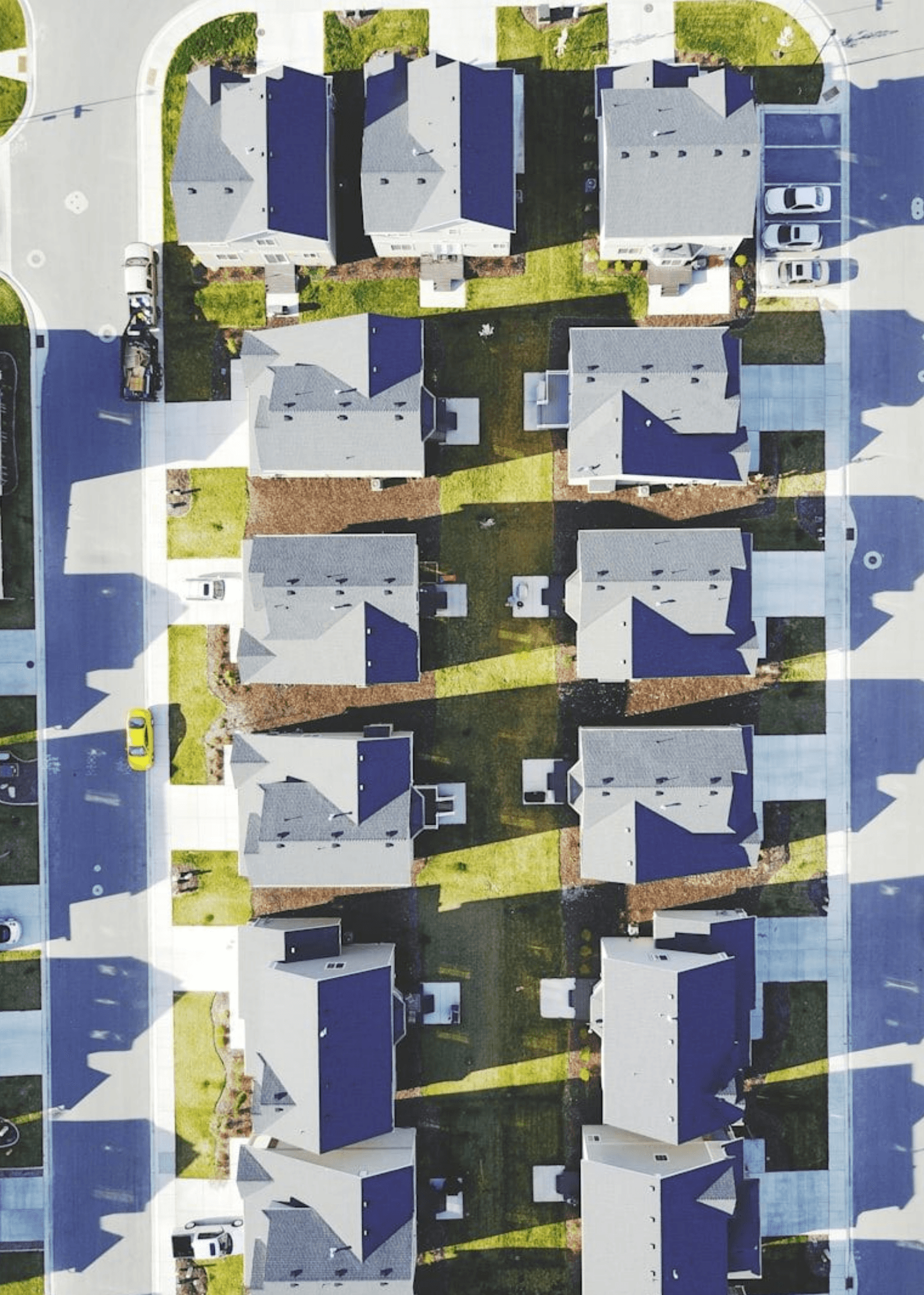 Aerial view of suburban houses with dark blue roofs