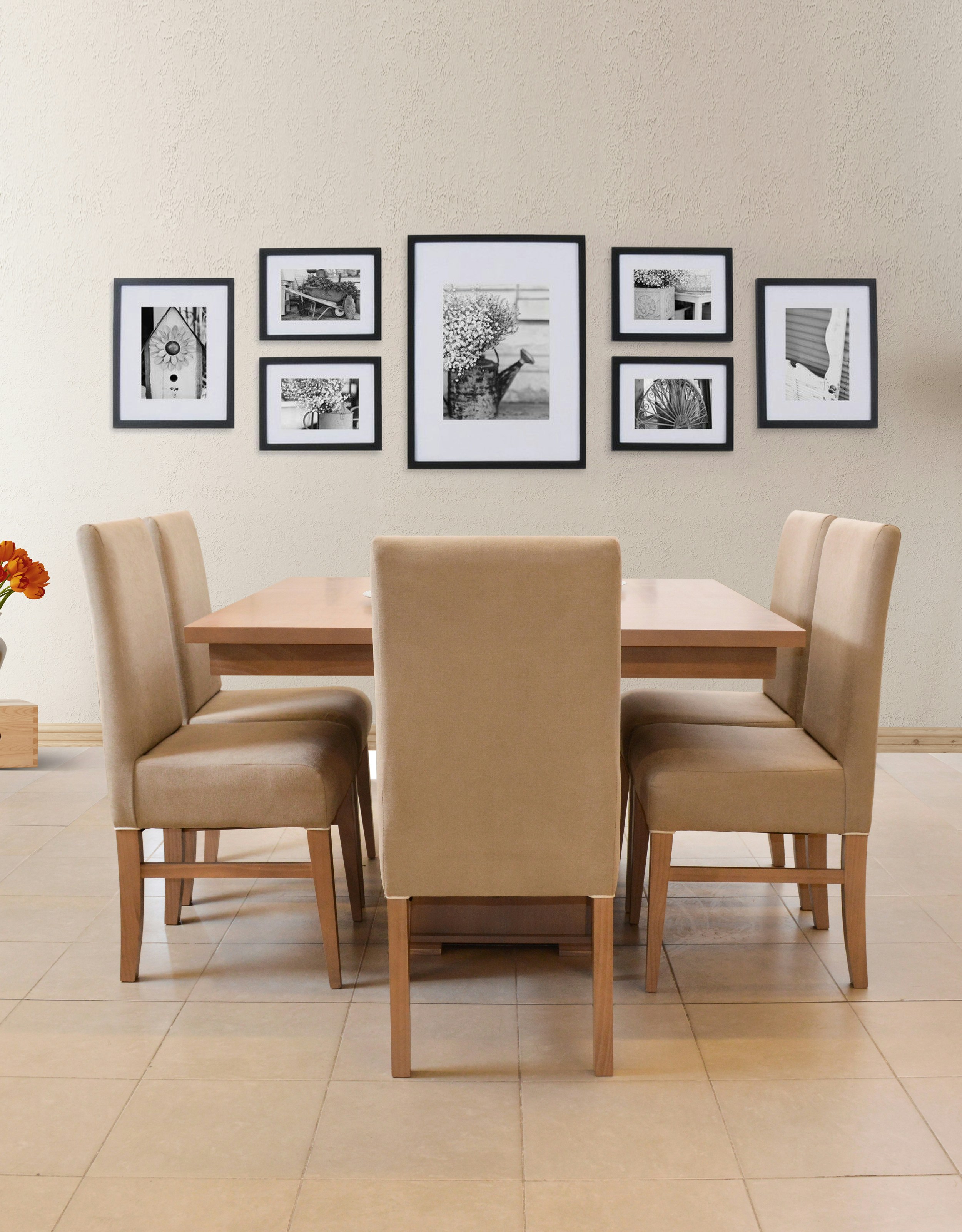 Dining table with chairs and framed artwork