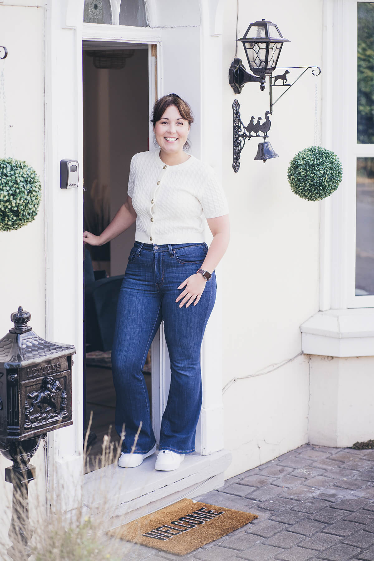 Aniko Rucz, short-term rental host and mentor, smiling and opening the door