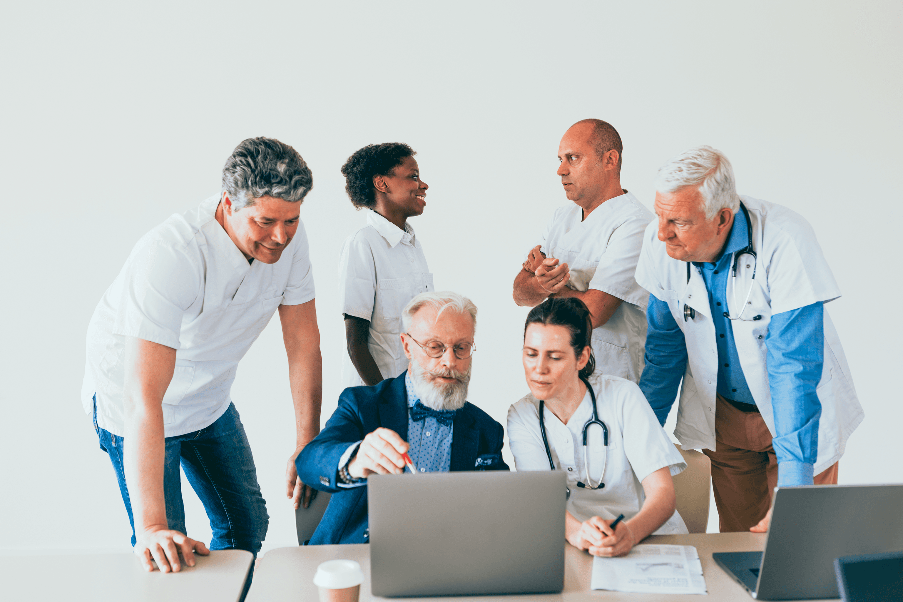 Healthcare software team reviewing interoperability specs on a laptop, comparing HL7 messaging vs FHIR APIs for data exchange and build effort decisions.