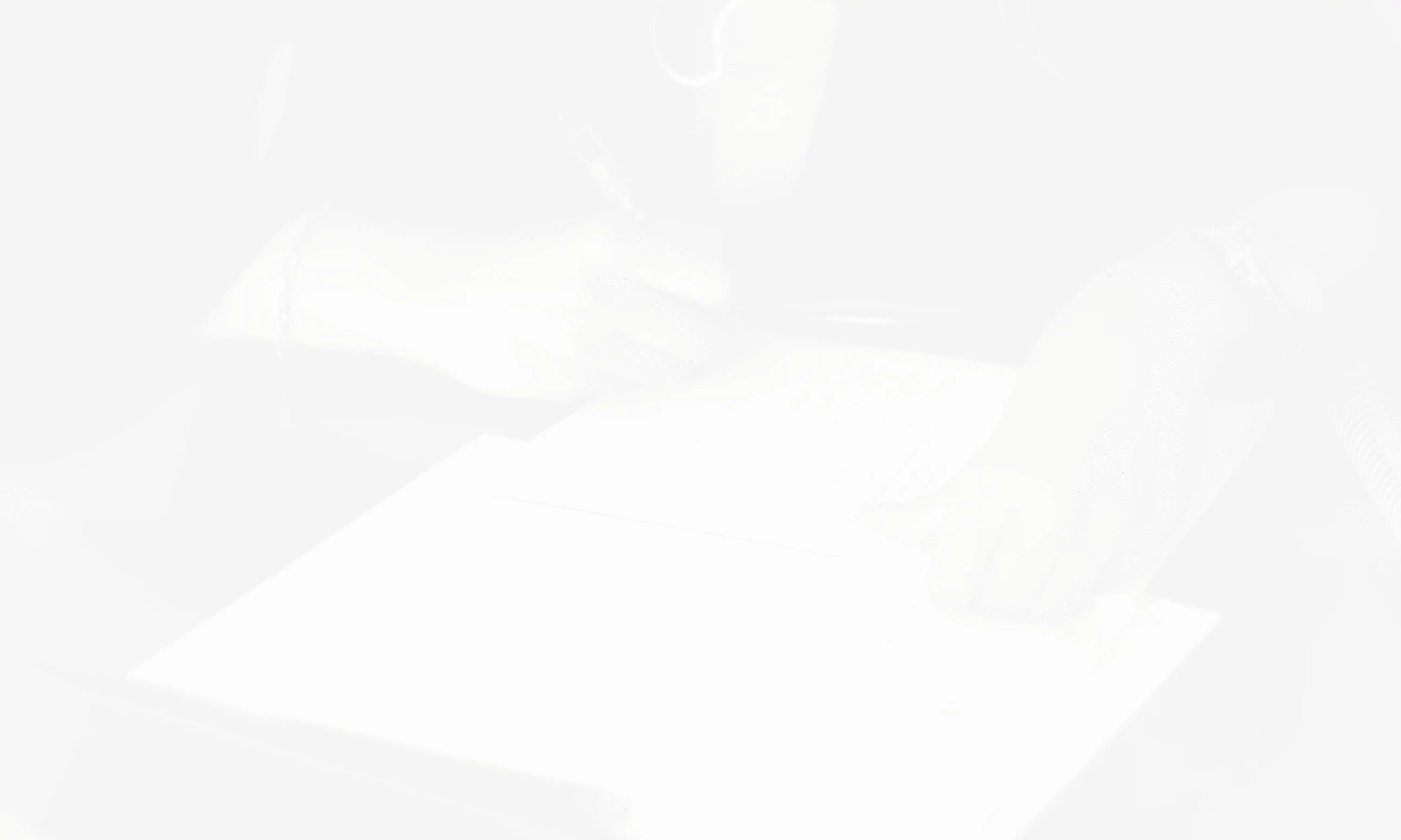 a person writing on a piece of paper