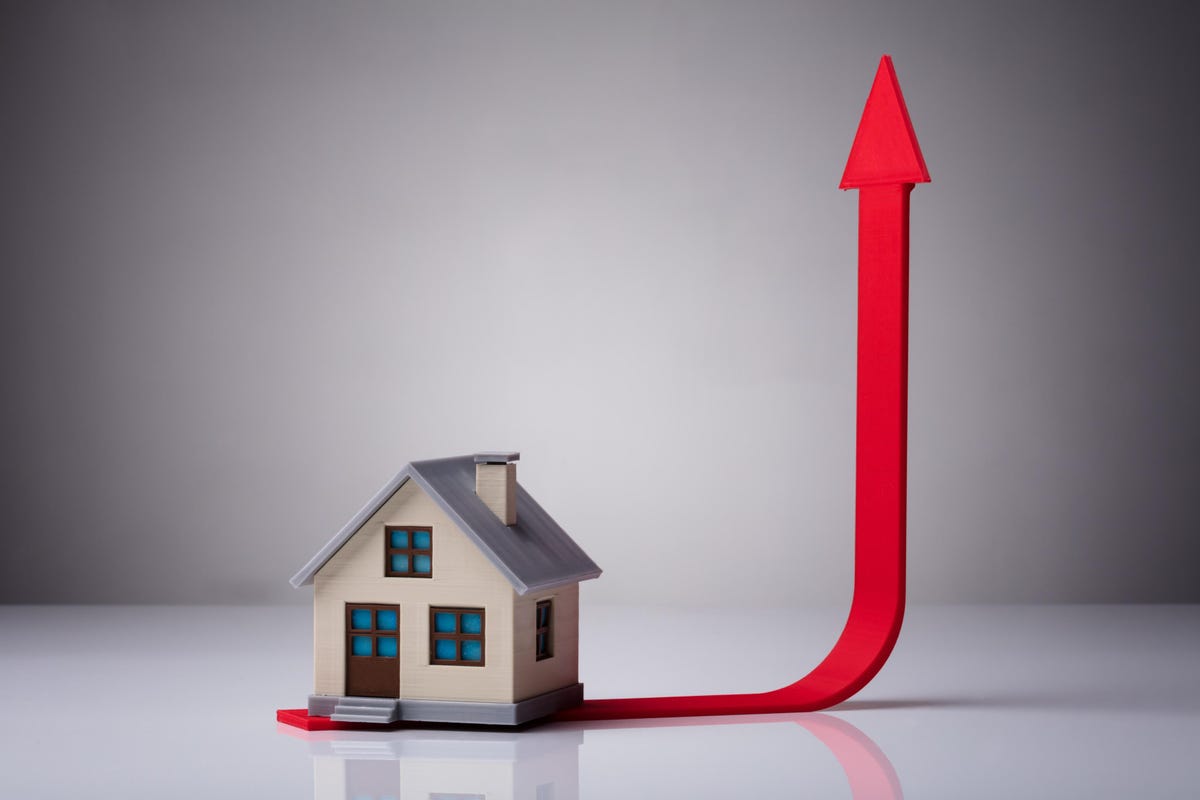 Model house with red arrow pointing up