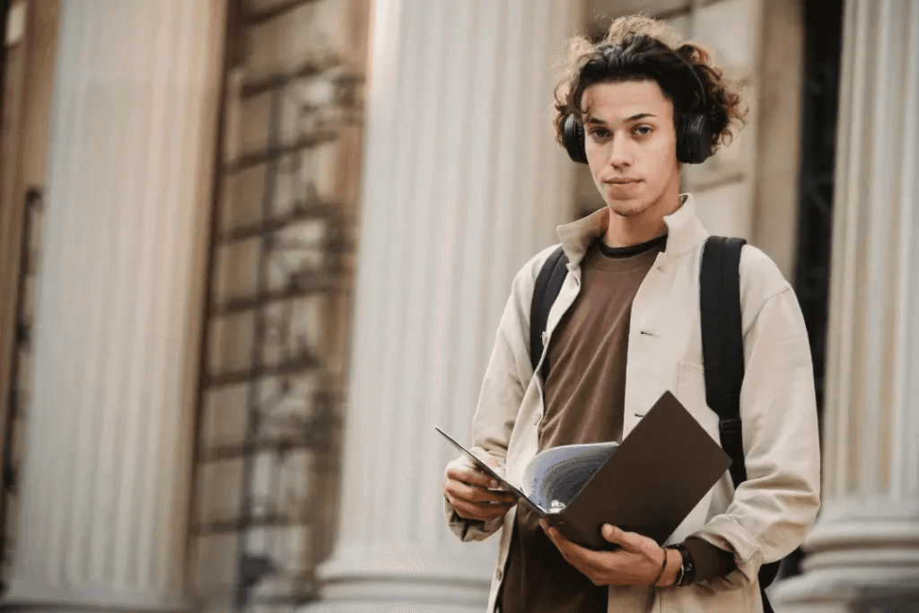 High school student working on research paper at desk before senior year college applications