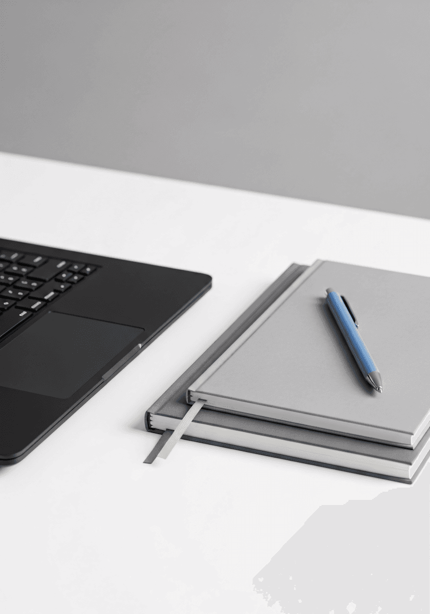 laptop next to a back on desk