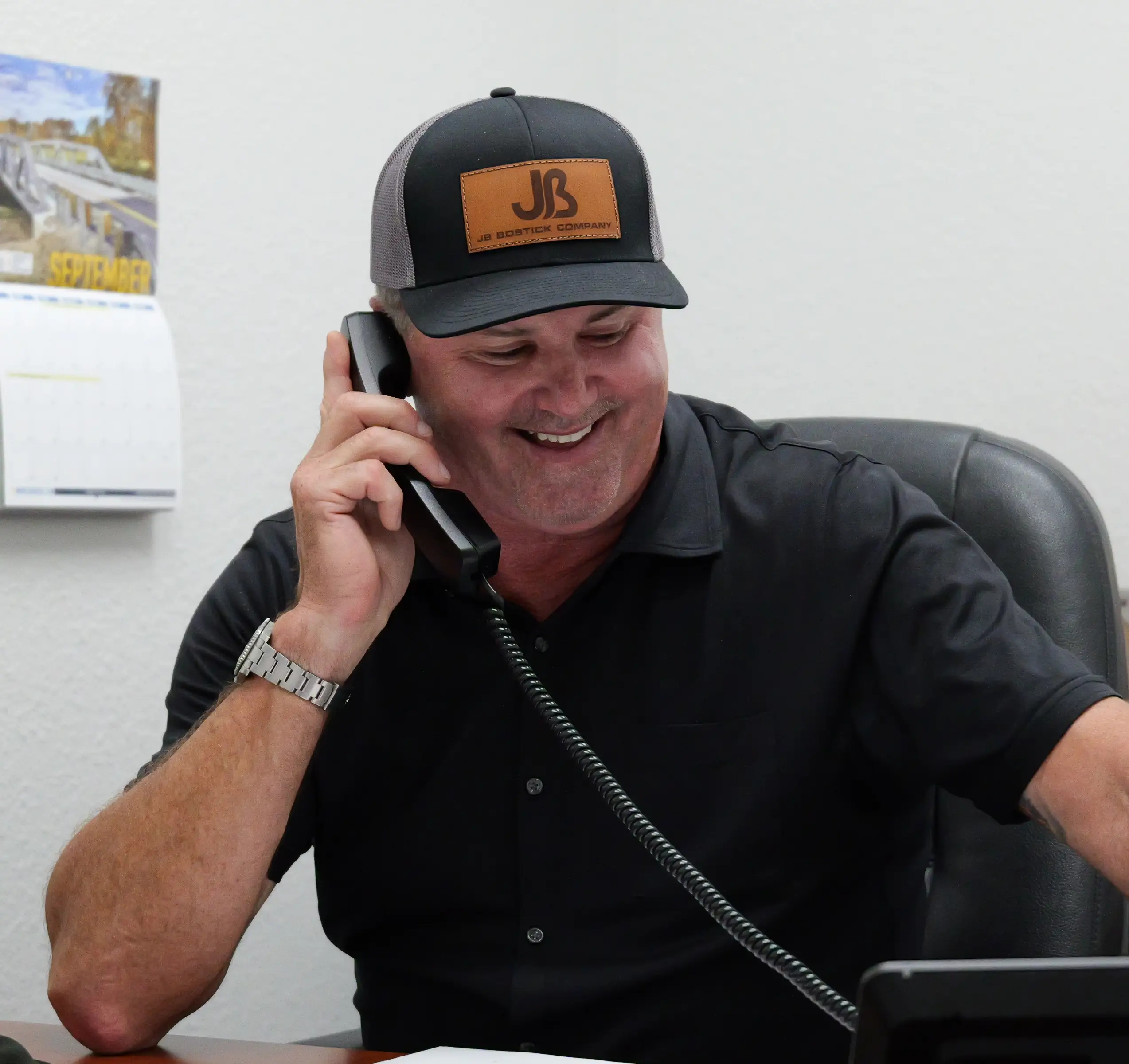 Salesman at desk talking on phone to client