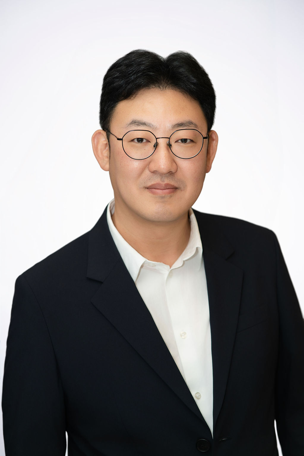 Scientist looking through a microscope in a lab.