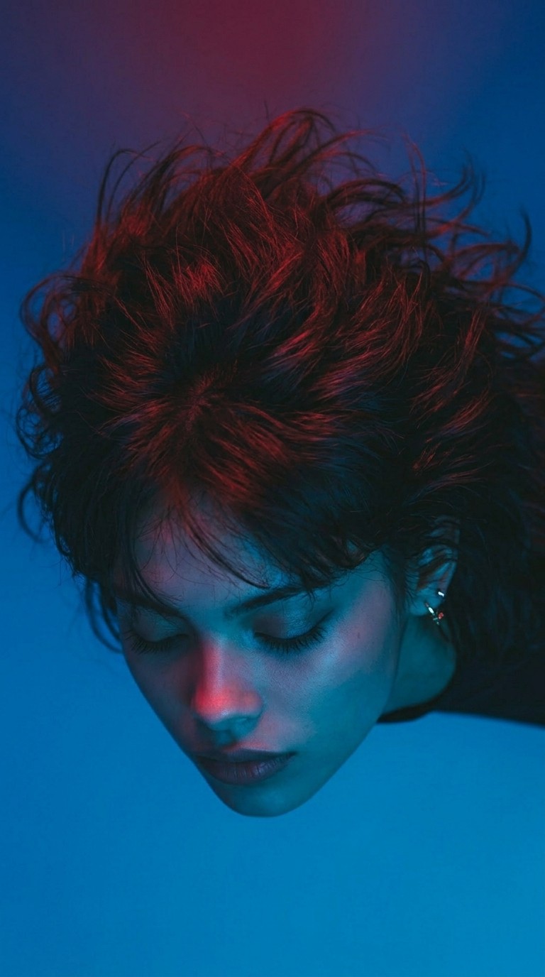 Profile of a face with high contrast between blue and red lighting