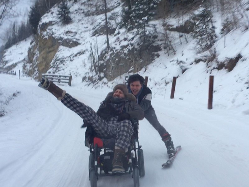 The wheelchair scene in action: two performers on the snow-covered road