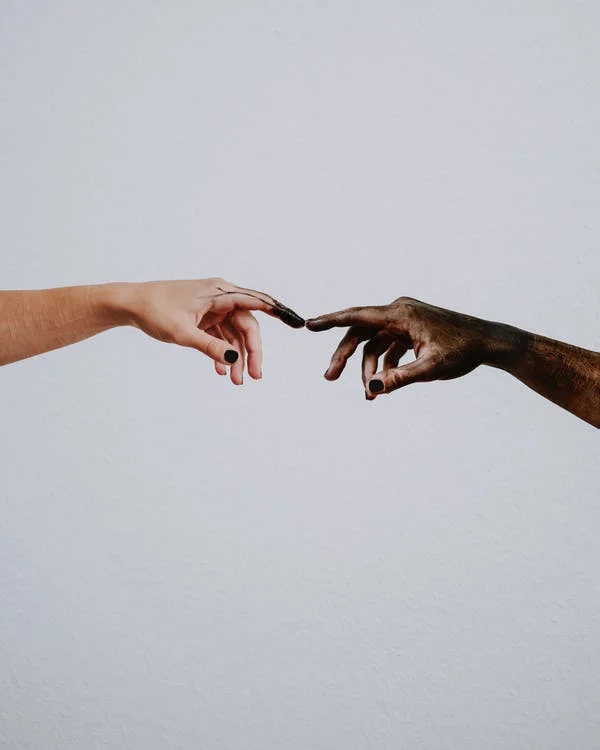 An image showing two hand touching by their fingers