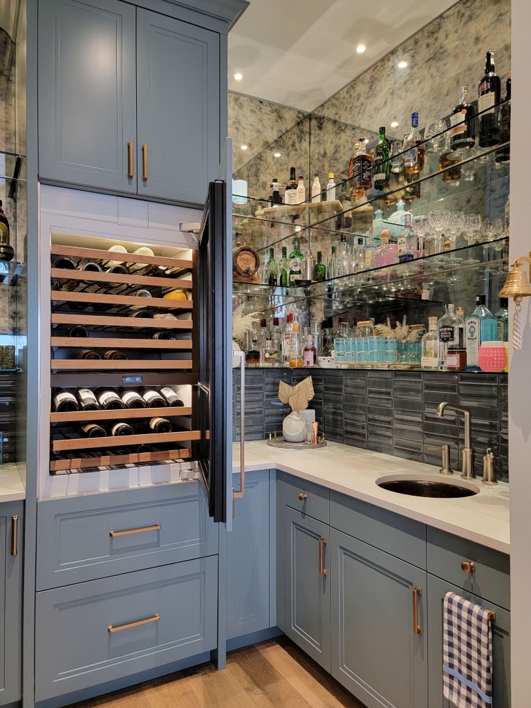 Image of Luxury home bar design with wine fridge, wet bar, and elegant cabinetry by KHD Homes.