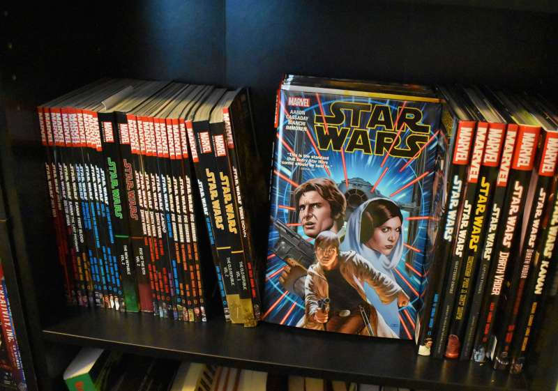 A shelf full of star wars comics