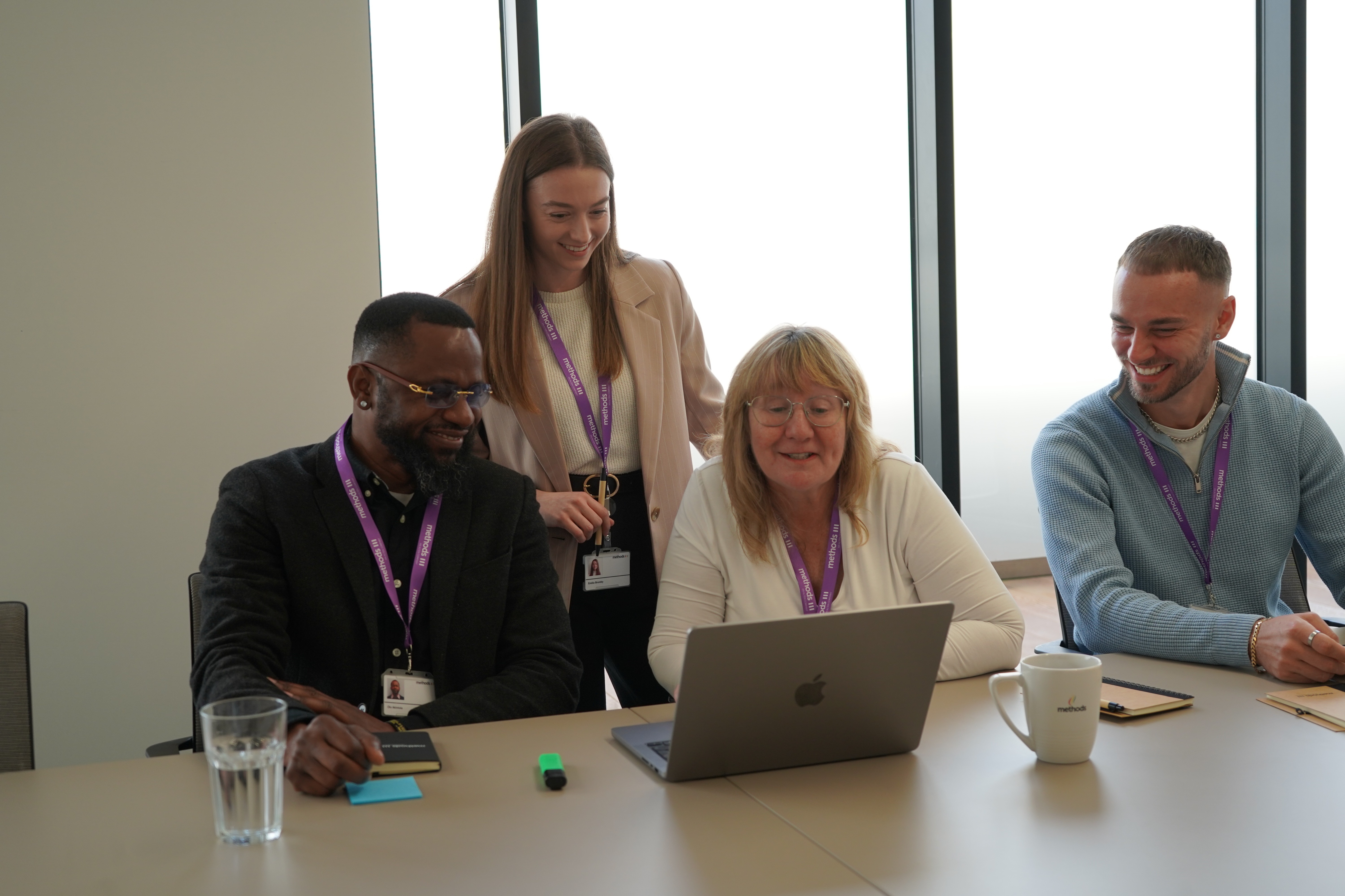A young person with long, wavy hair sits in front of a plain background, looking directly at the camera.