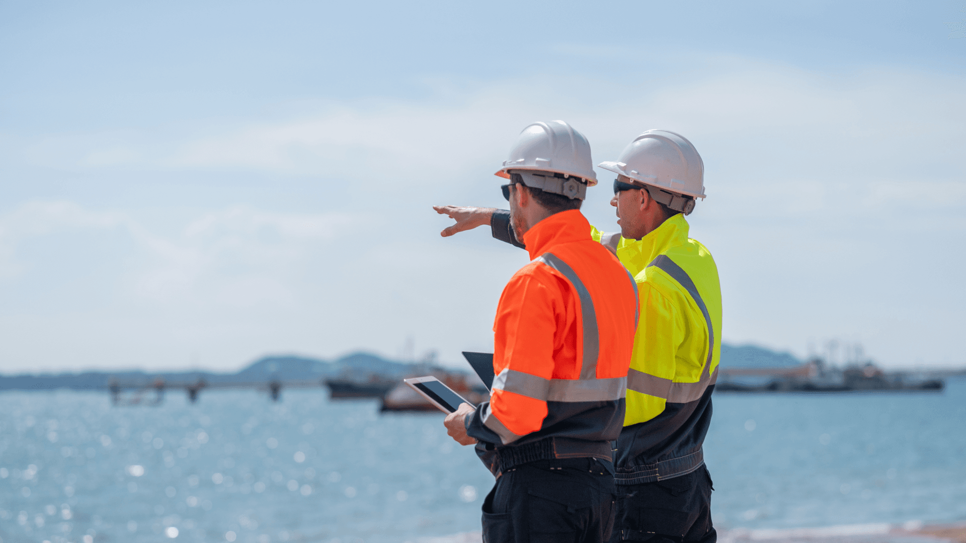 Facilities and engineering professionals reviewing plans on site, reflecting the growing demand for energy managers and net zero skills in UK FM teams.