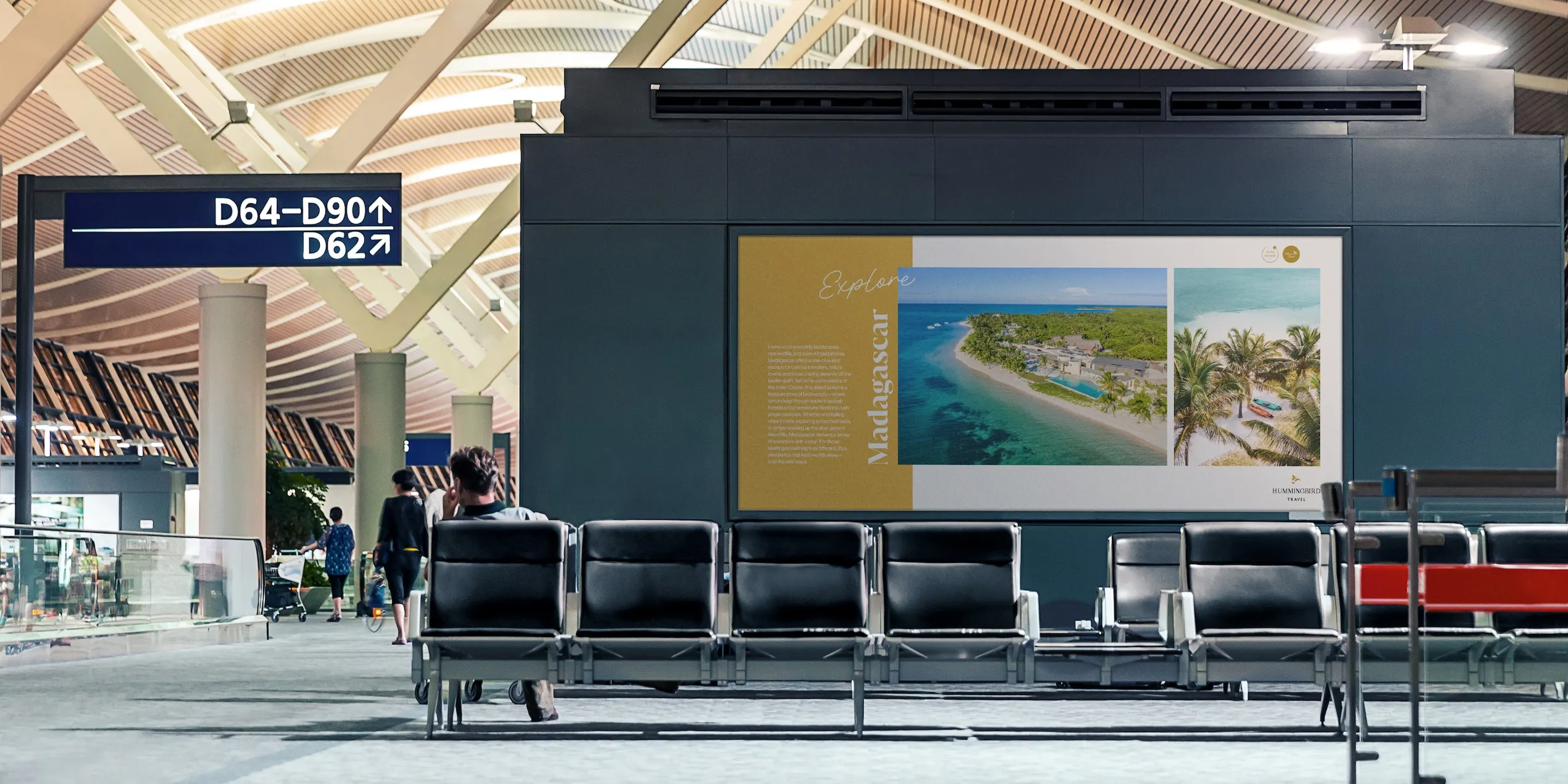 Hummingbird Travel billboard in an airport setting