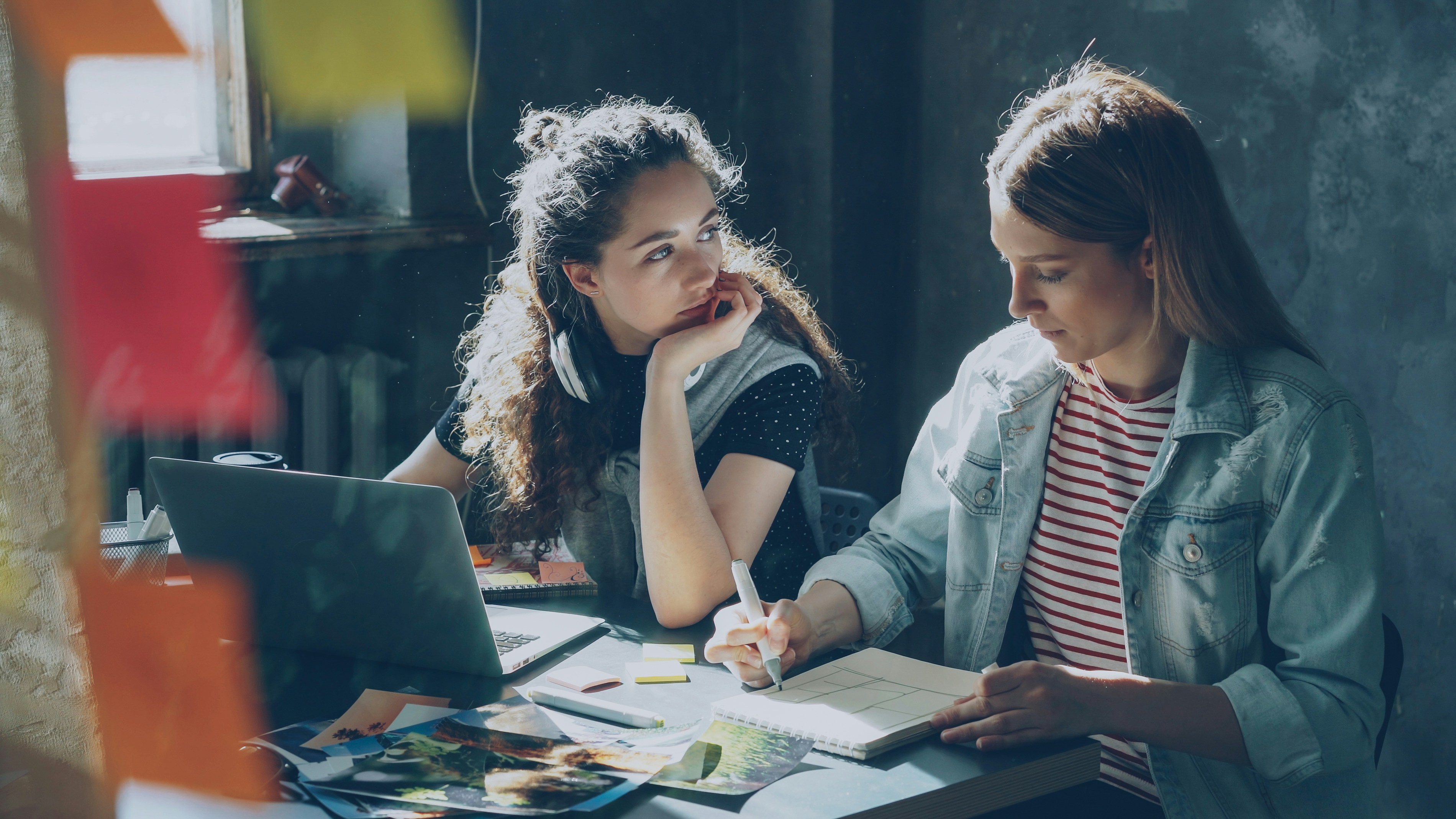 Two women are working together on a project.