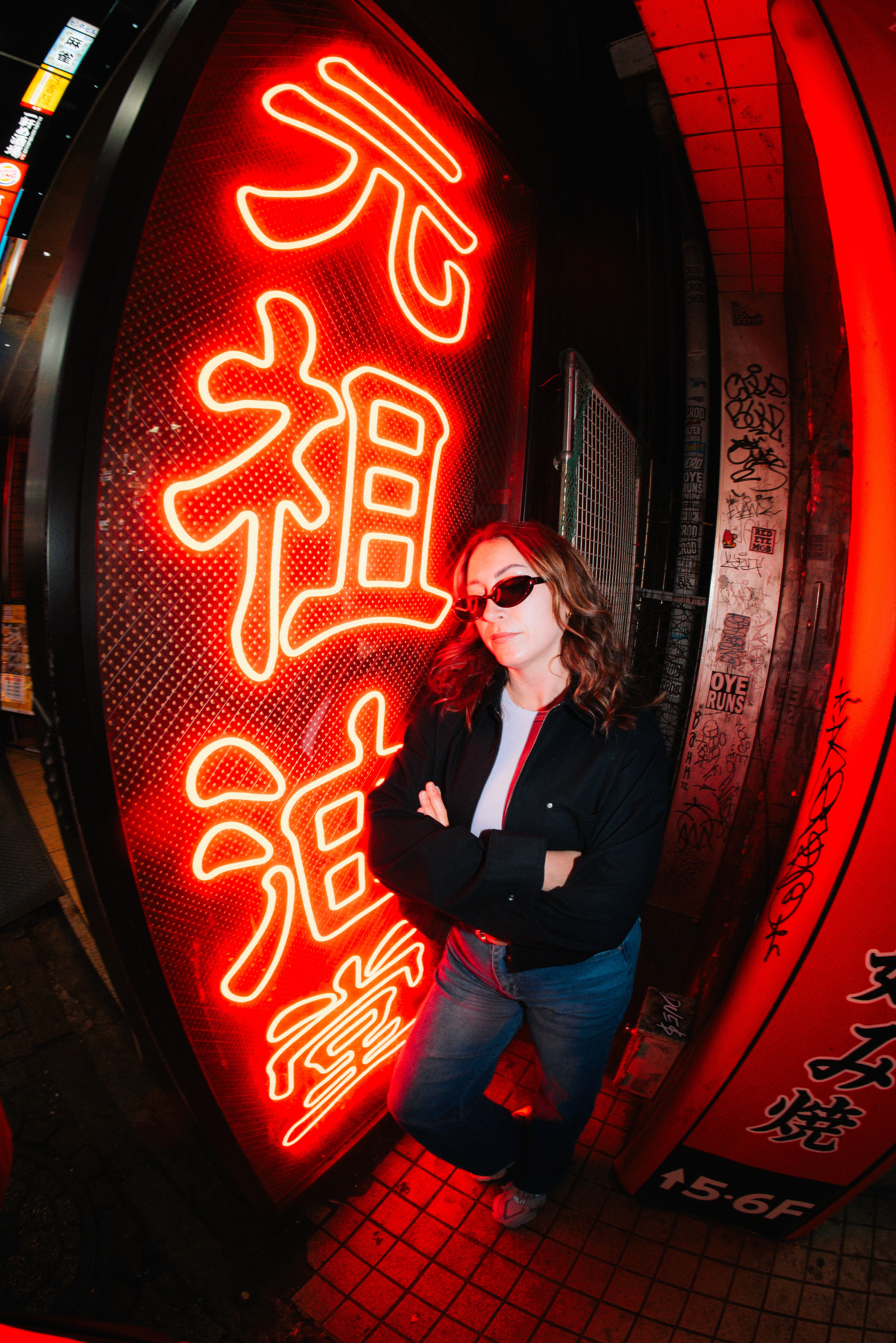 Bryna in Shibuya at a neon sign