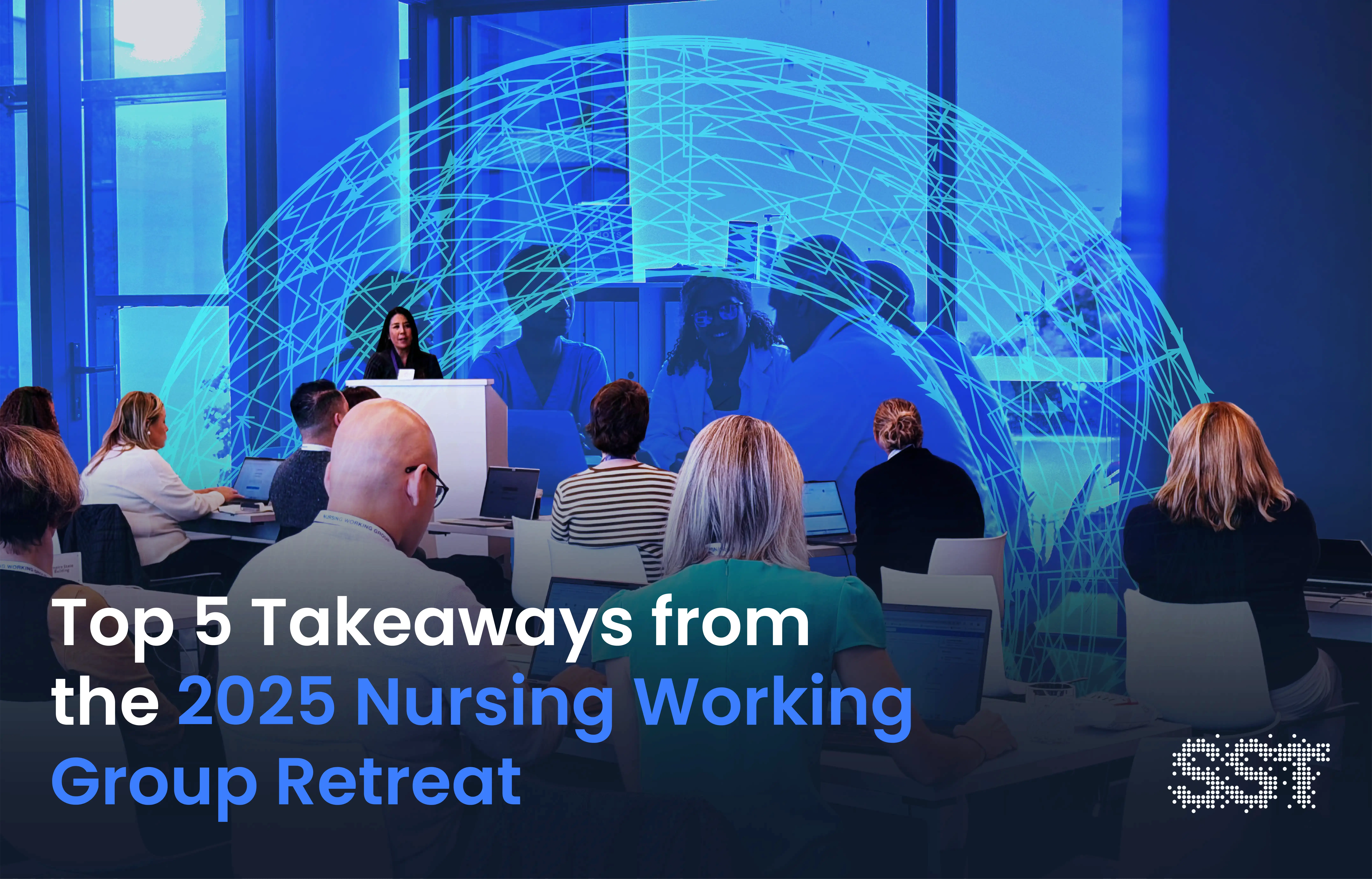 A group of nursing leaders sitting in a room together with a speaker at the front of the room