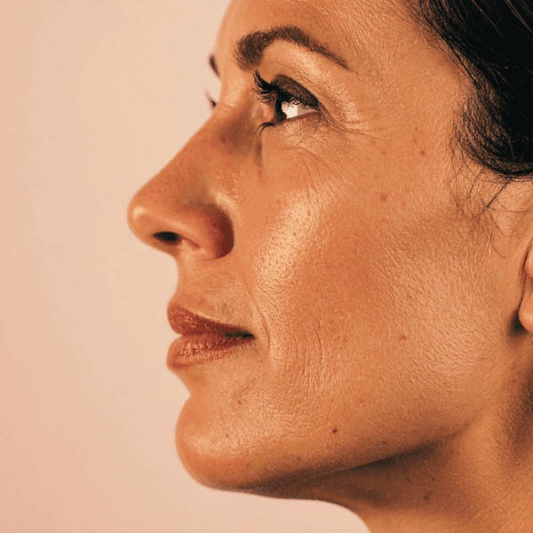 Close up of woman facing to the left with beautiful clear skin