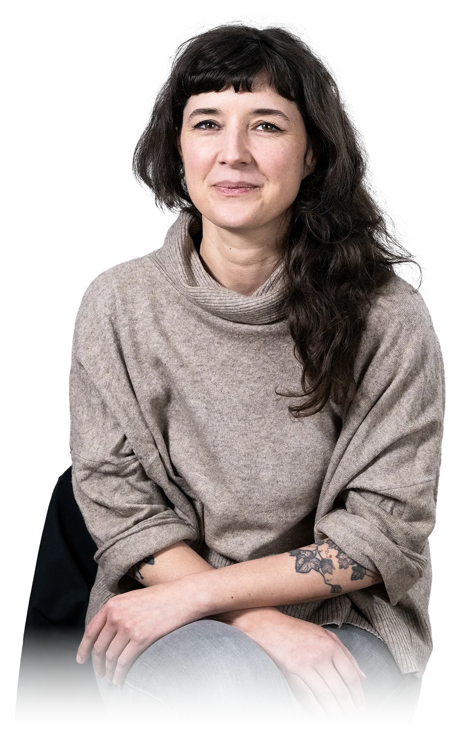 A woman sits cross-legged with eyes closed, wearing a white blouse and a long purple skirt, looking serene.