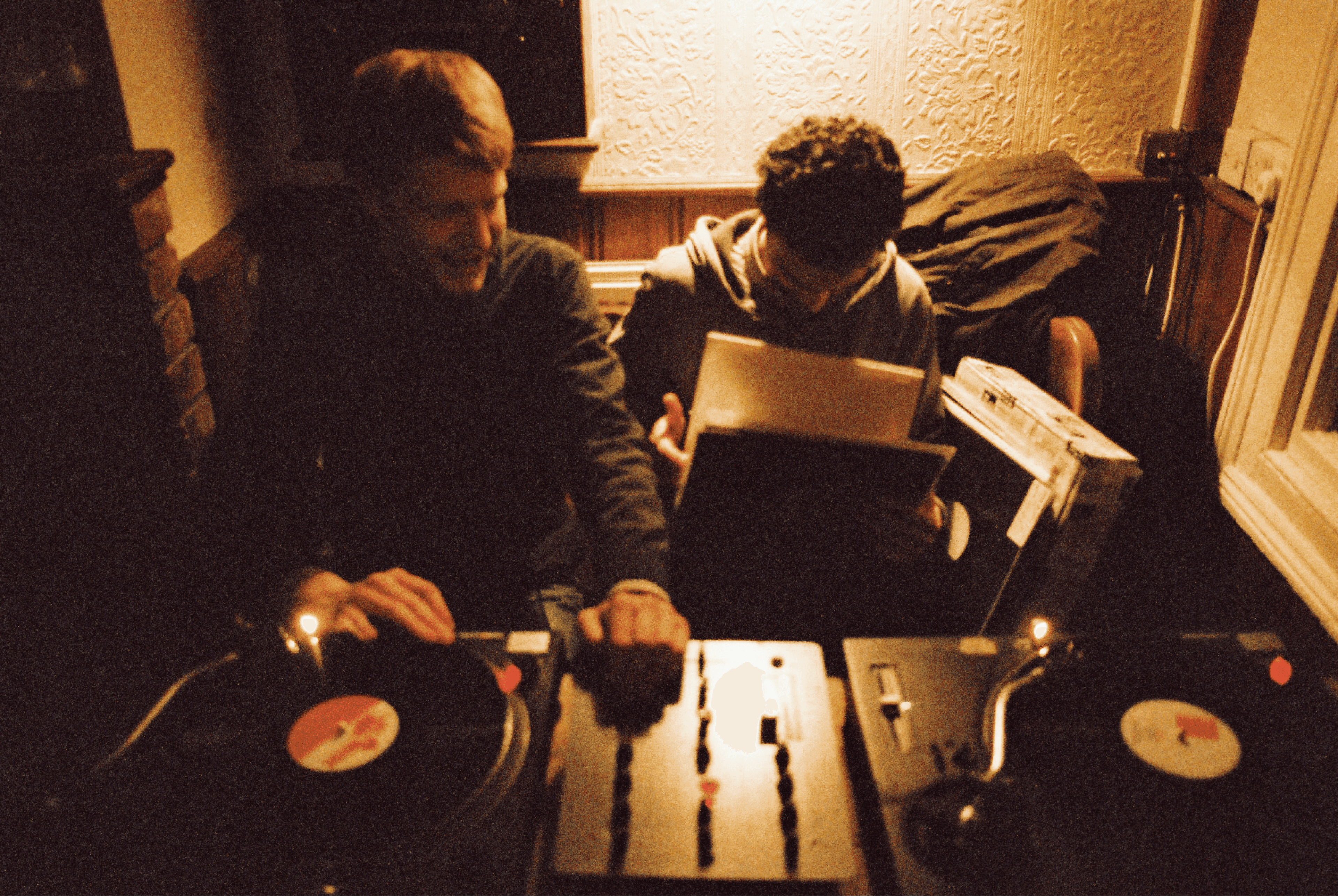 Chris Farrel and Peverelist sat next to each other behind a pair of turntables in The Bell pub Bristol playing records together